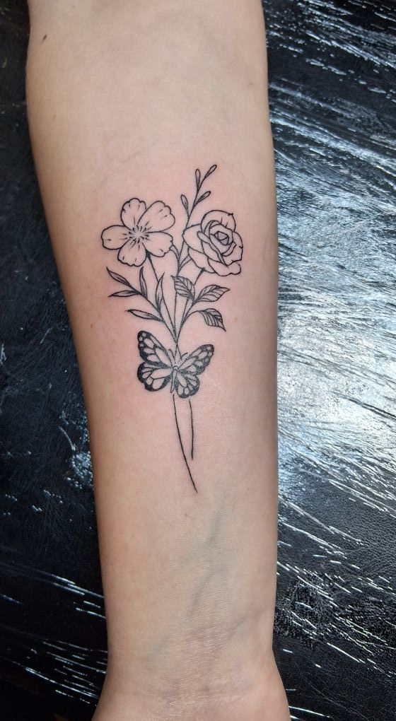 Tattoo of playing cards and poker chips on an arm. Black and gray shading with club suit visible.