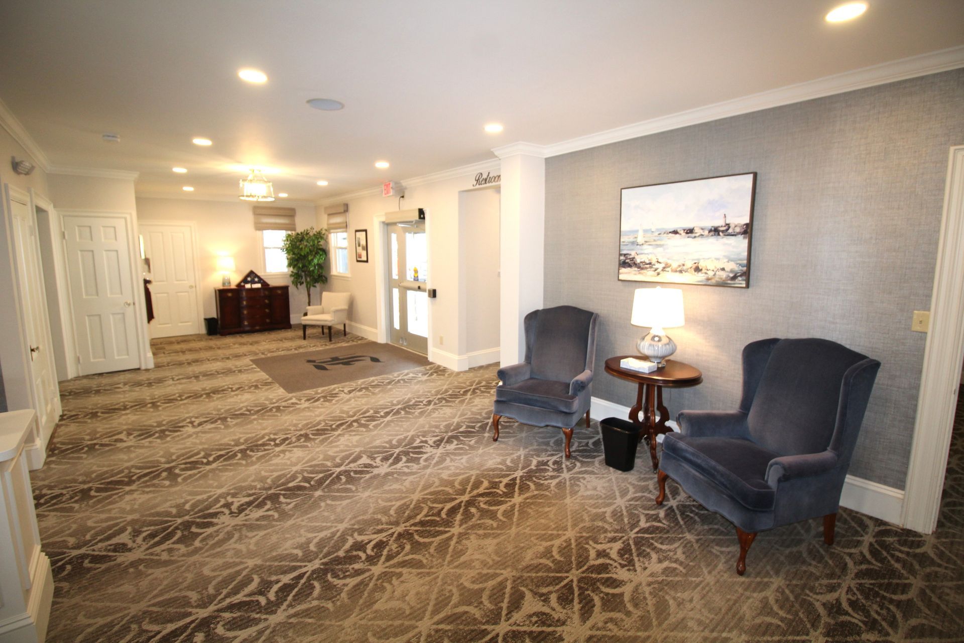 There are two chairs and a table in the room.