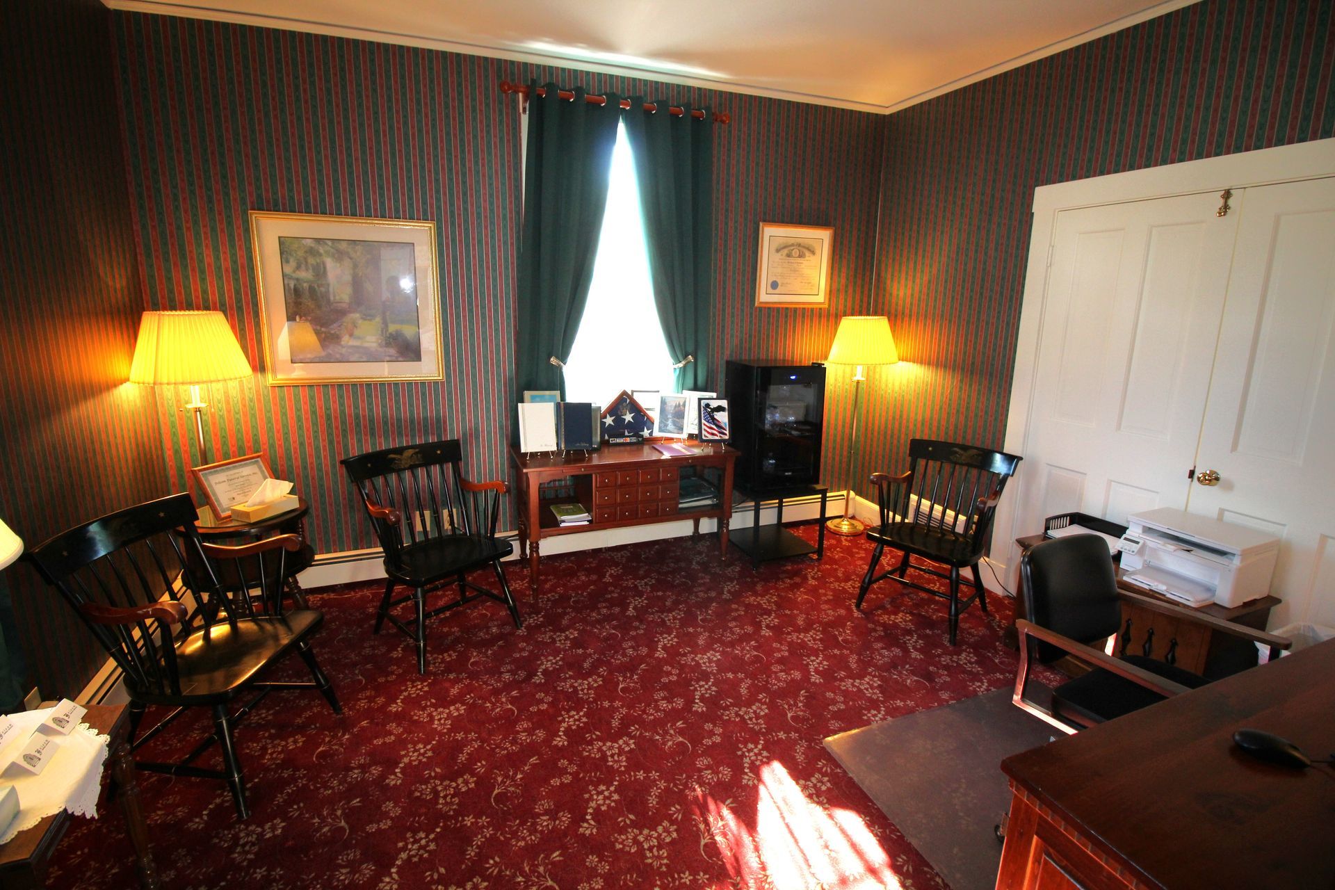A living room with a red carpet and chairs