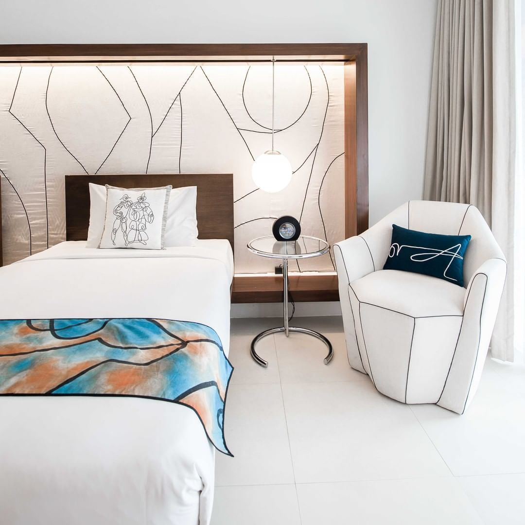 A hotel room with two beds and a chair