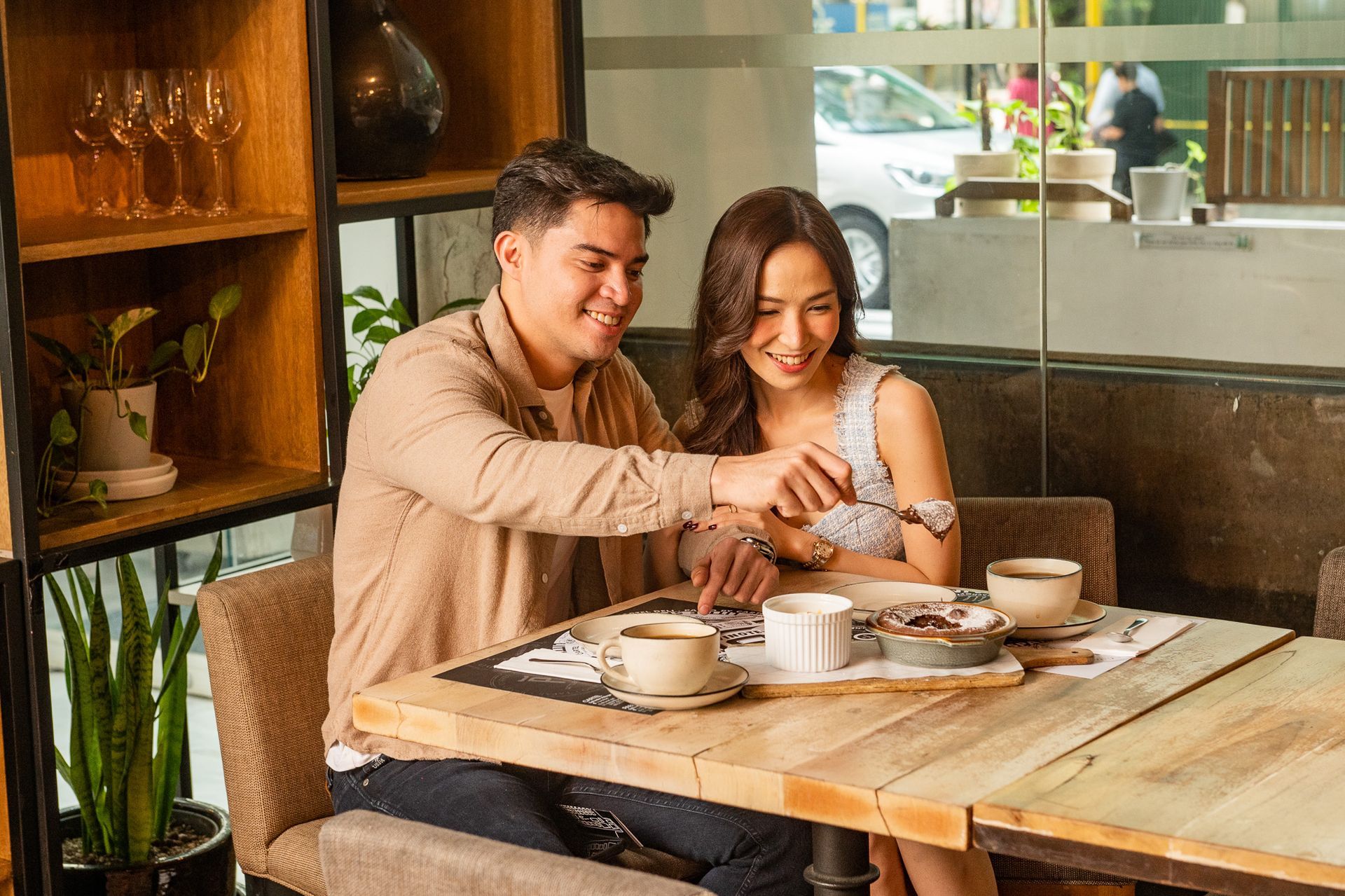 Couple enjoying breakfast at boutique Makati hotel's restaurant with coffee and pastries