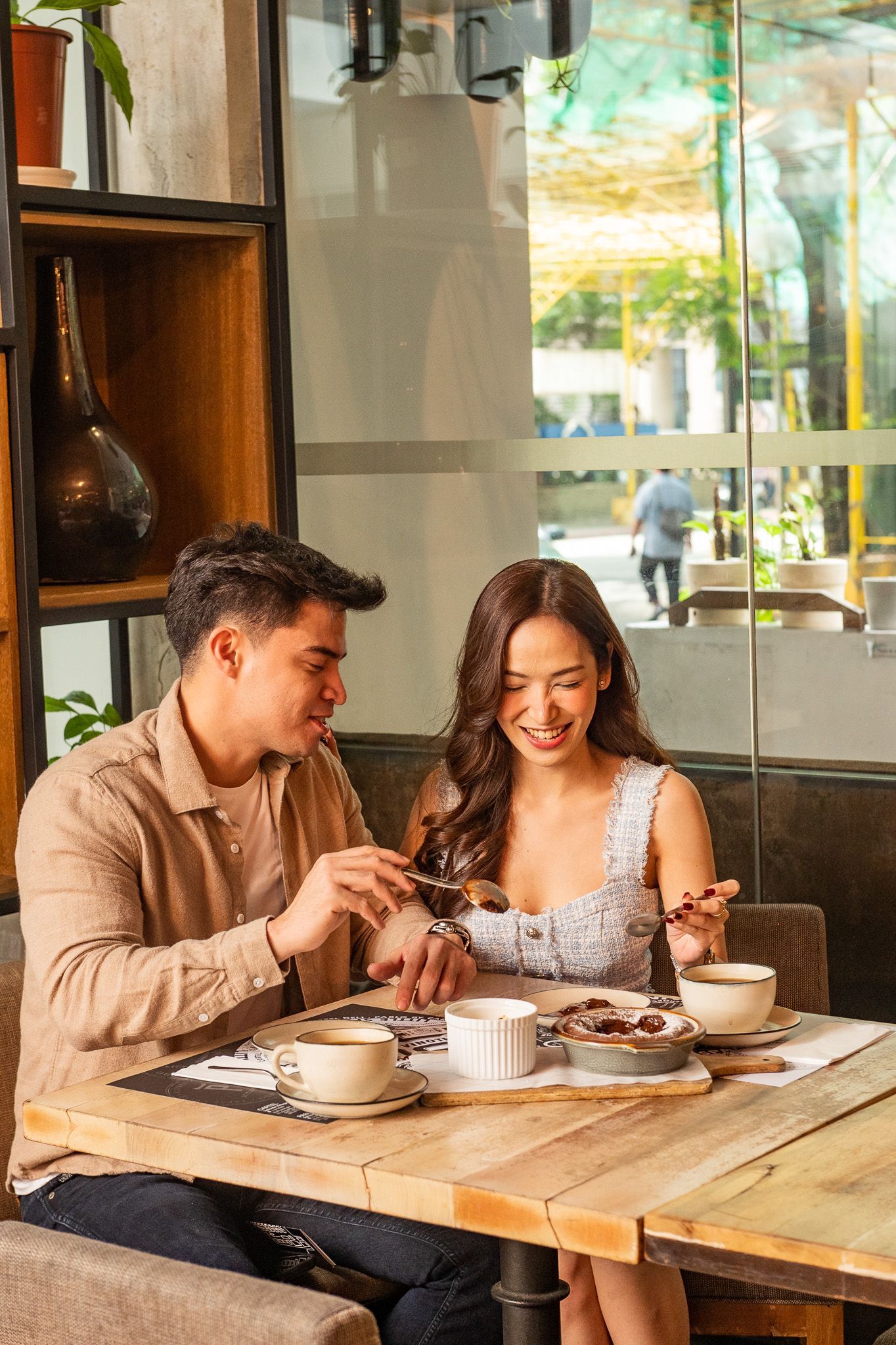 Couple enjoying coffee and dessert at a cozy Makati cafe