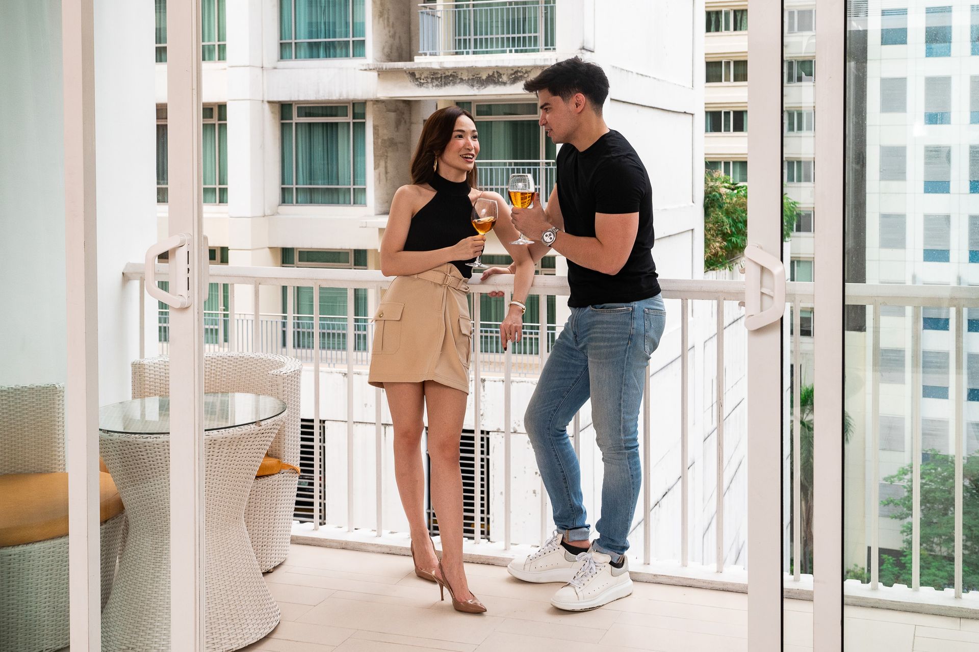 Couple toasting wine on hotel balcony at The Picasso Boutique Residences Ma