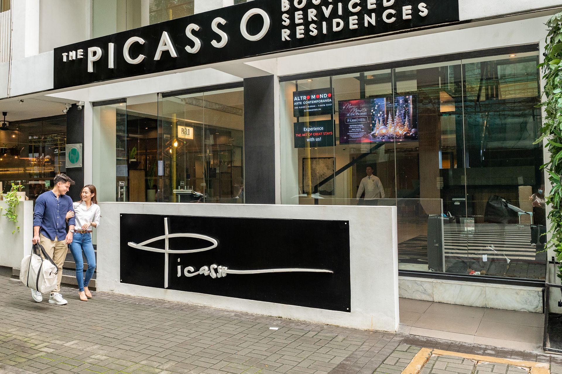 The Picasso Boutique Serviced Residences guests in front of the facade.