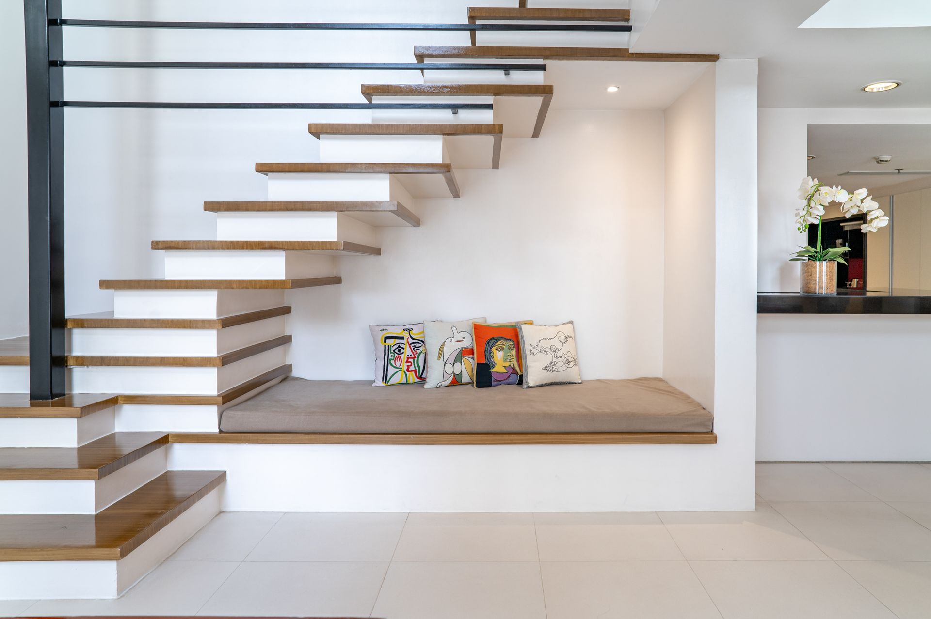 A staircase with a cushioned seat underneath it