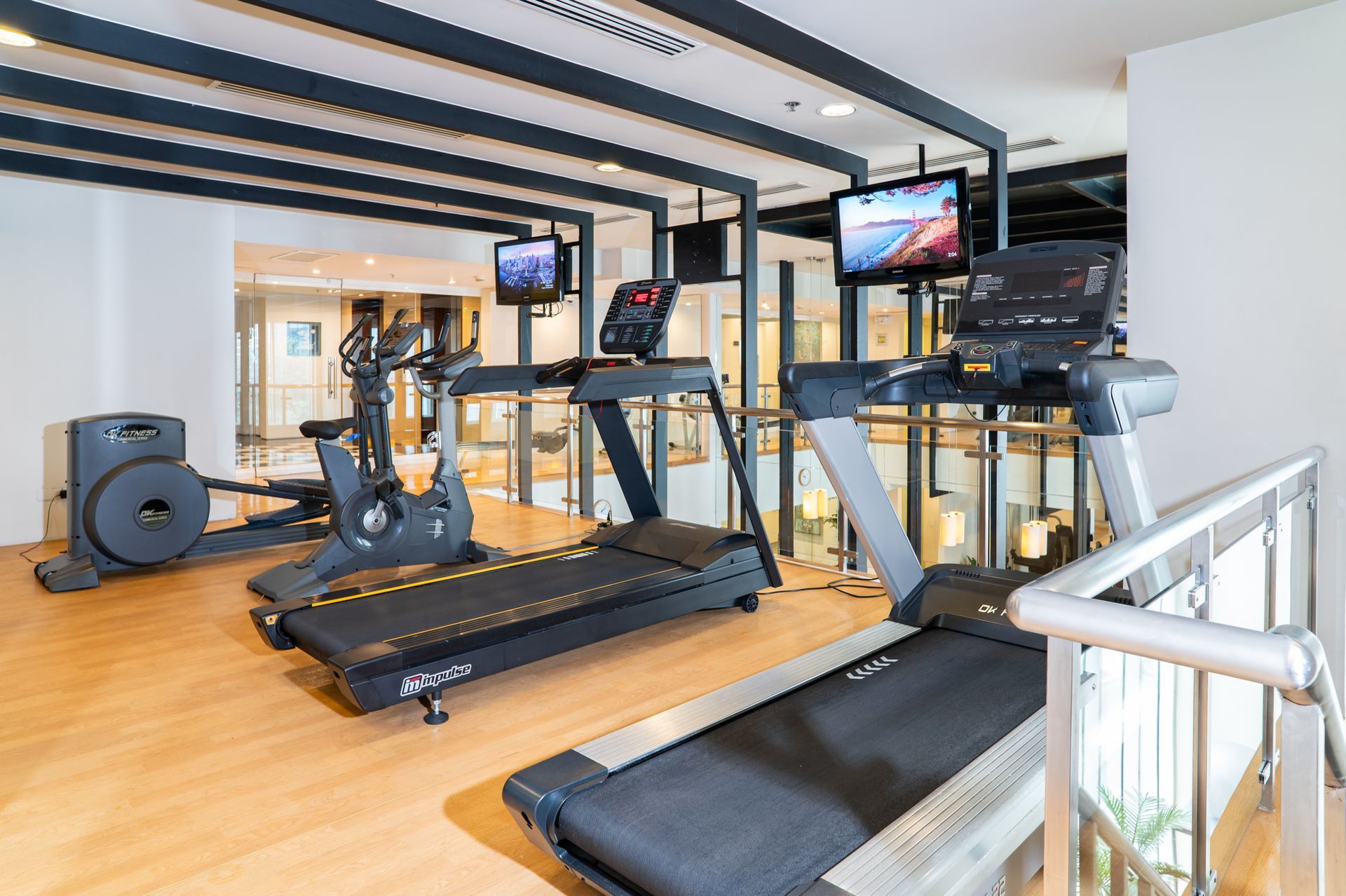 High-end cardio equipment in boutique hotel gym with mirrored walls