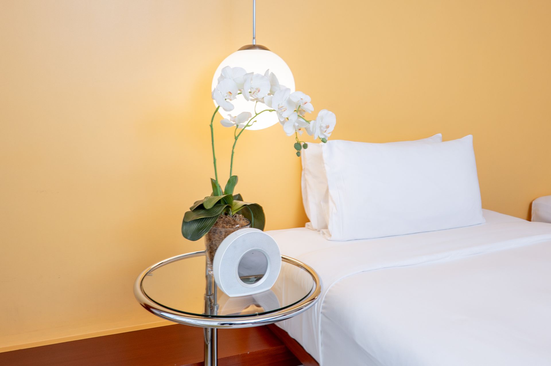 A hotel room with a bed and a table with toilet paper on it