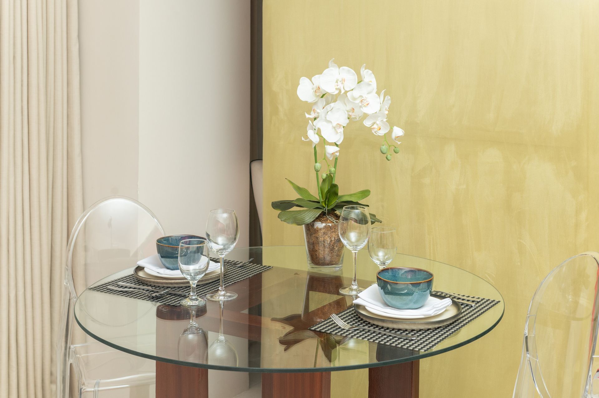 A glass table with a vase of flowers on it