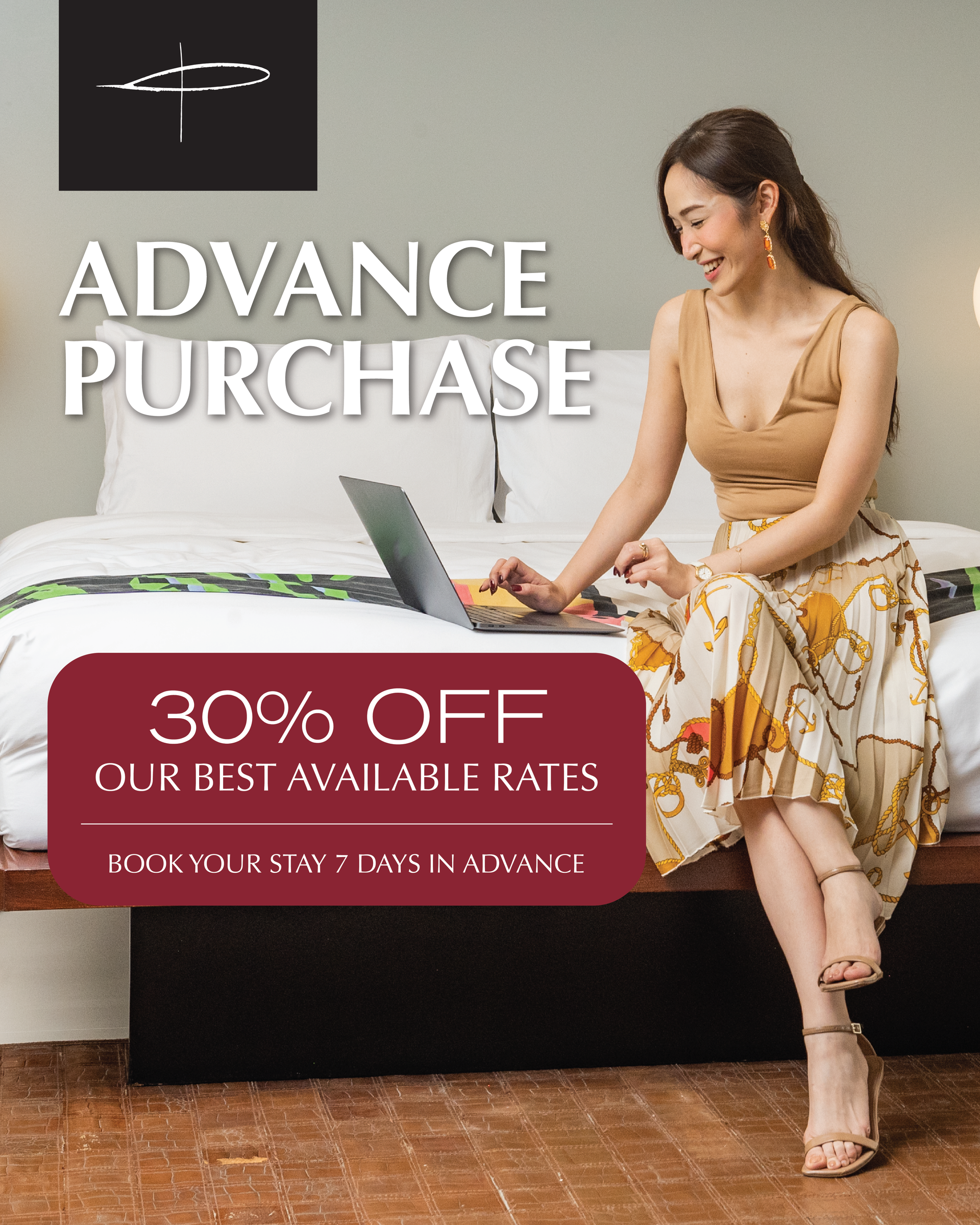 A woman is sitting on a bed with a laptop and a sign that says advance purchase