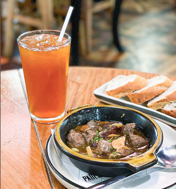 A Spanish dish and iced tea from Pablo Bistro at Picasso Hotel Makati