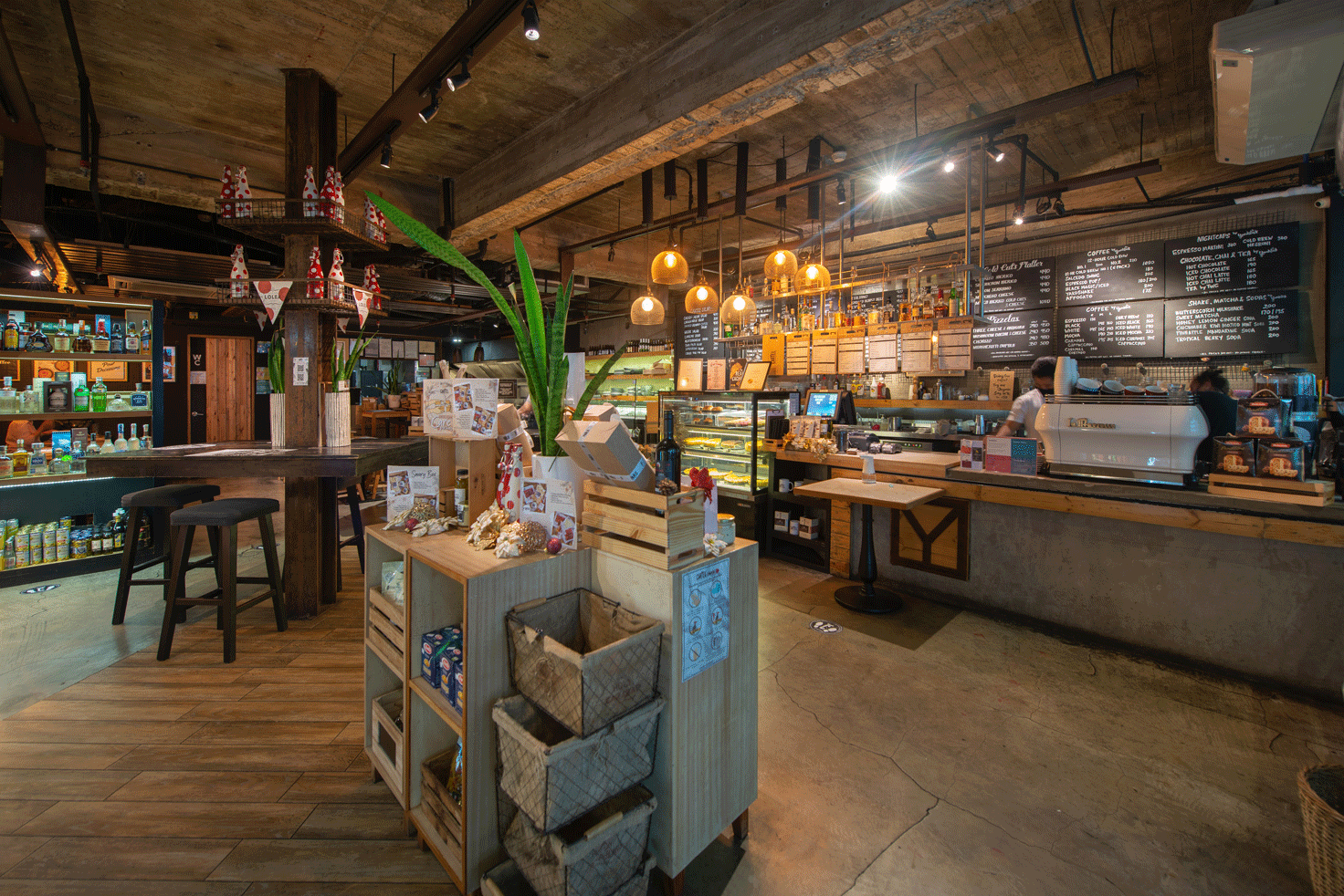 Cartel Deli with a lot of tables and chairs and a counter at Picasso Hotel Makati.