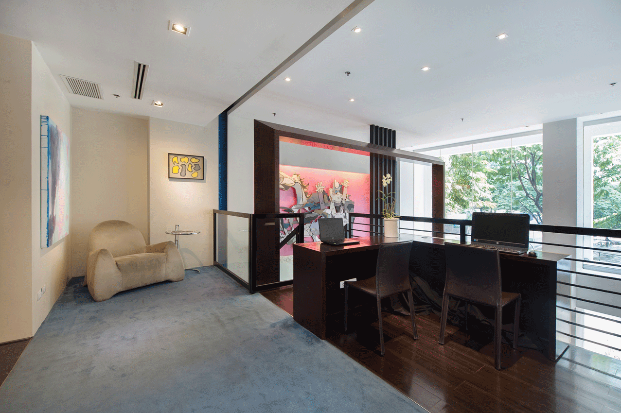Gallery-style interior with artistic lighting and modern design in boutique serviced residences Makati.