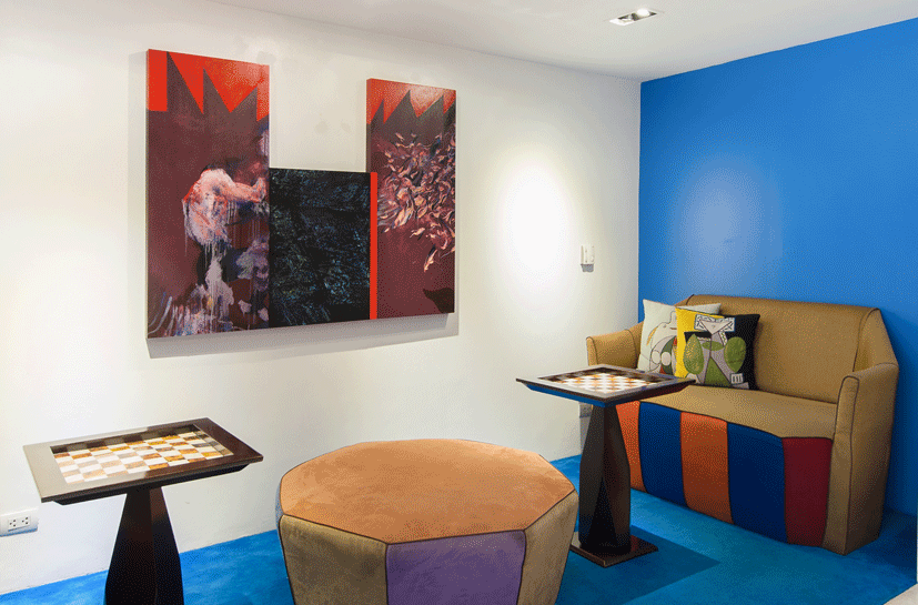 Modern living area in Picasso serviced residence with red accent wall and decorative pillows