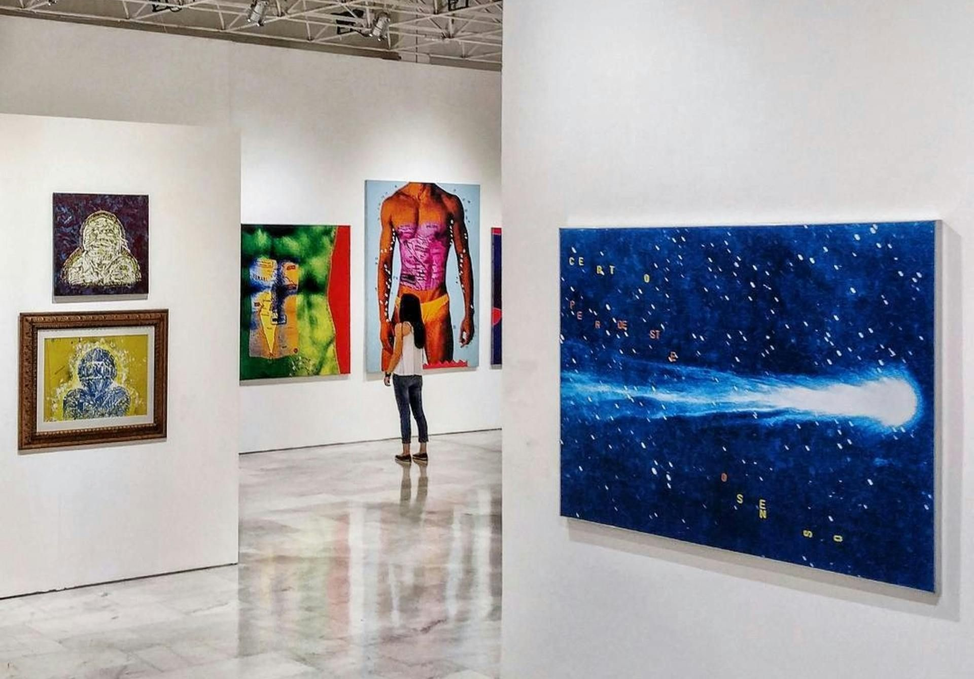 A bright, modern art gallery inside the Ayala Museum, showcasing contemporary Filipino art just a short walk from hotels in Makati.