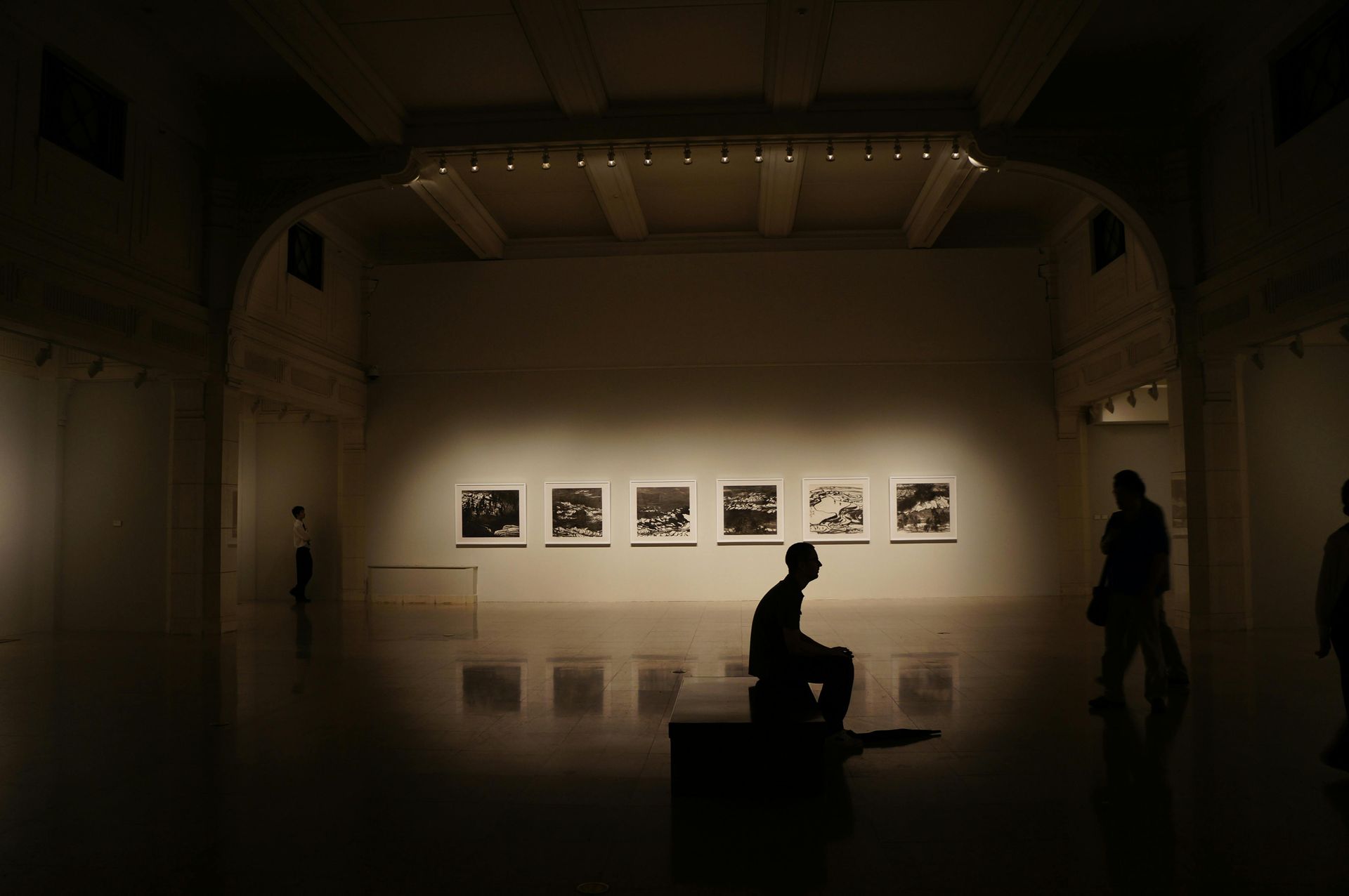 A visitor viewing a historical exhibit, such as the famous Diorama Experience, at the Ayala Museum located across from Greenbelt 5.