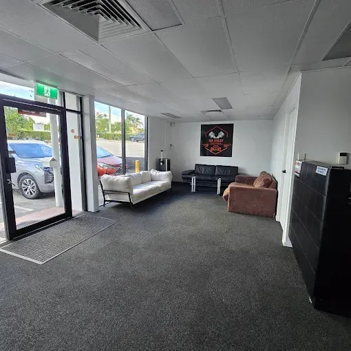 Sign for Quality Motors Air Conditioning, Tyre, and Service/repair. Building Exterior With Fire Hose — QA Oxley in Oxley, QLD