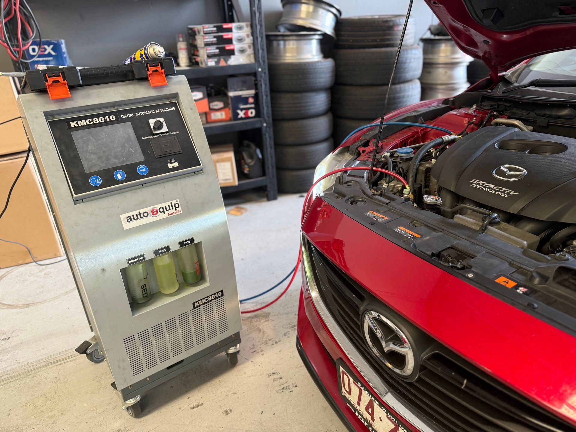 Mechanic Inspecting a Black Truck With the Hood Open in a Workshop — QA Oxley in Oxley, QLD