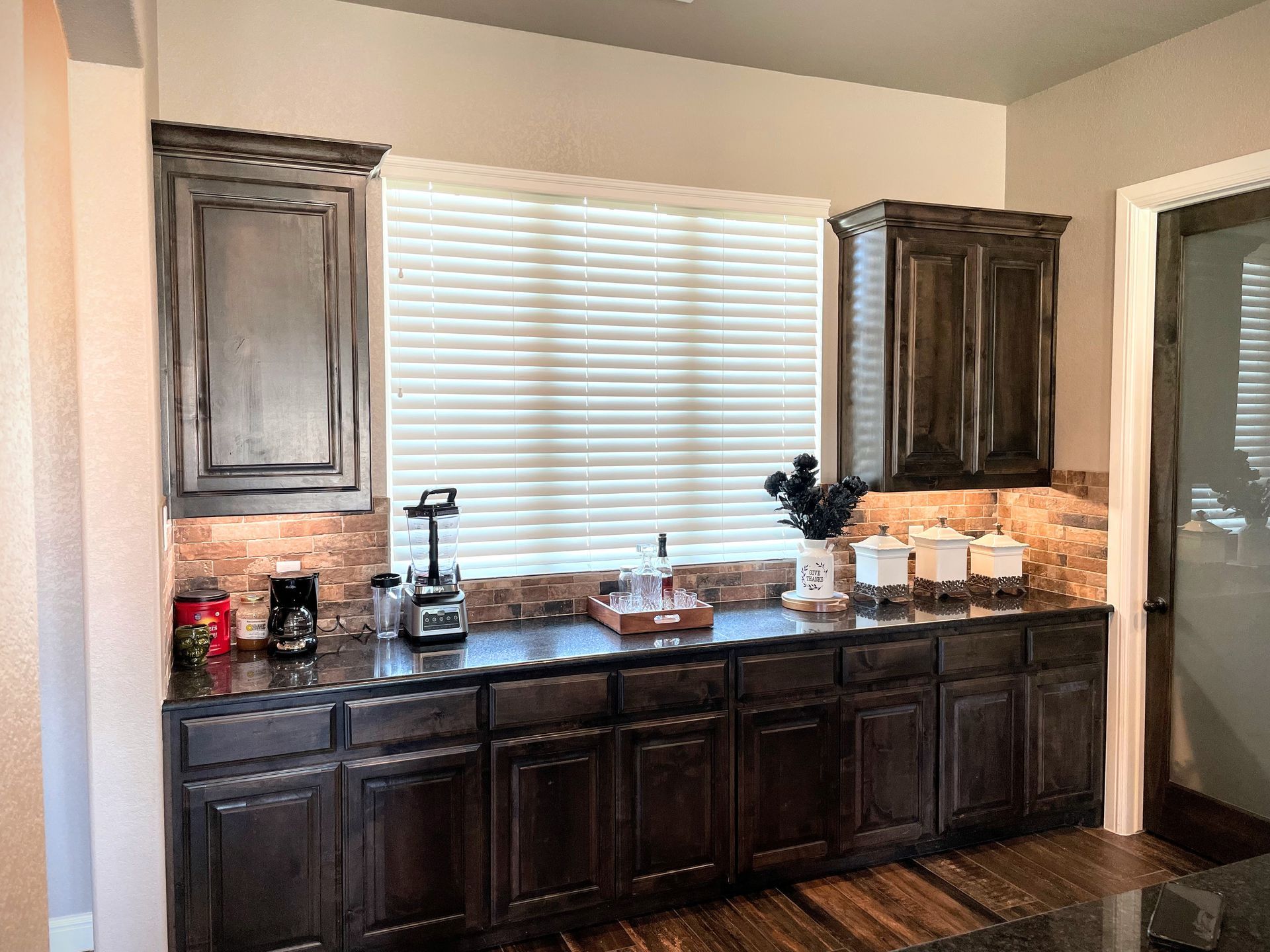 A kitchen with a lot of cabinets and a window.