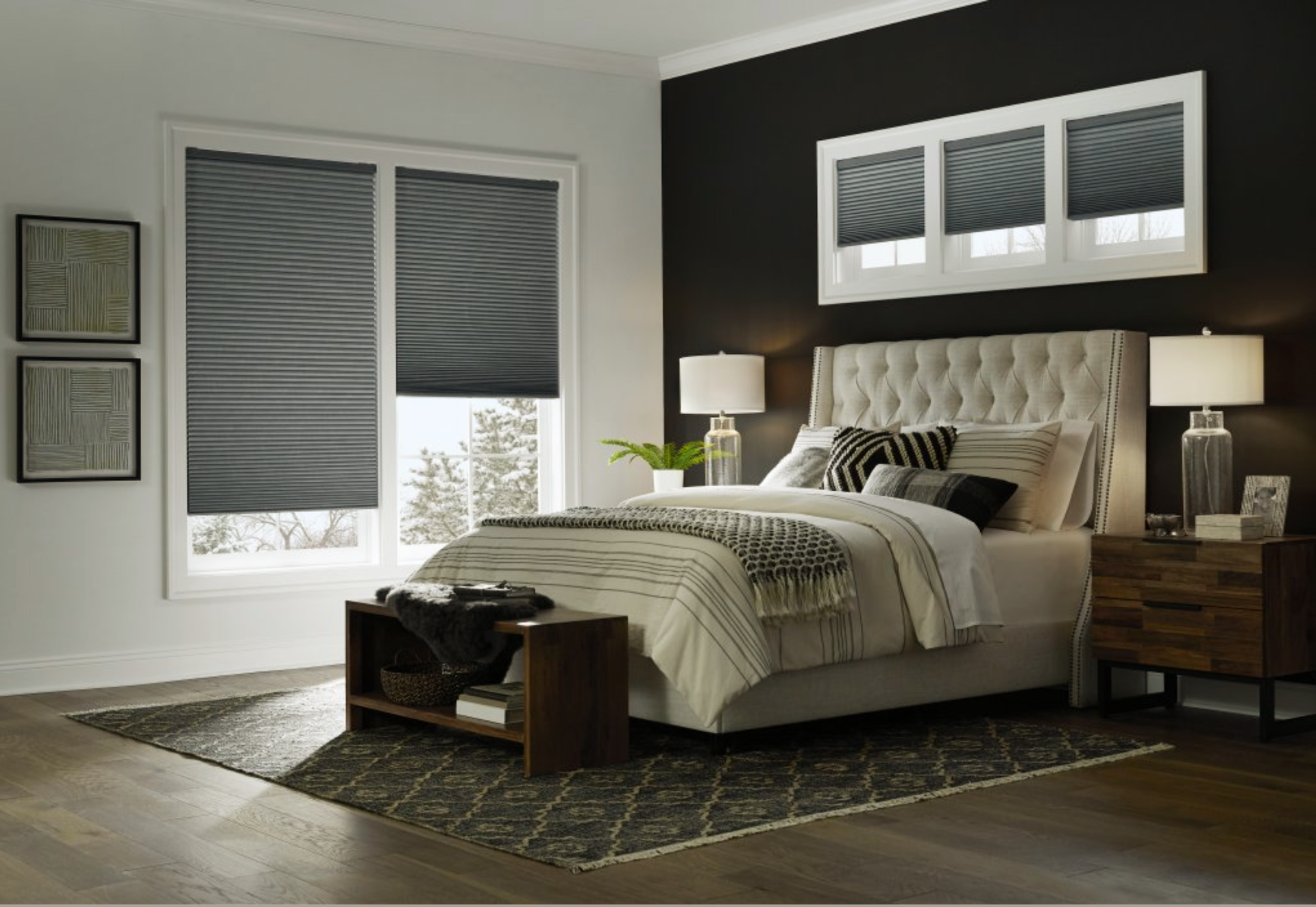 Cozy bedroom with dark gray blinds, a tufted headboard, bedside lamps, and a dark accent wall.