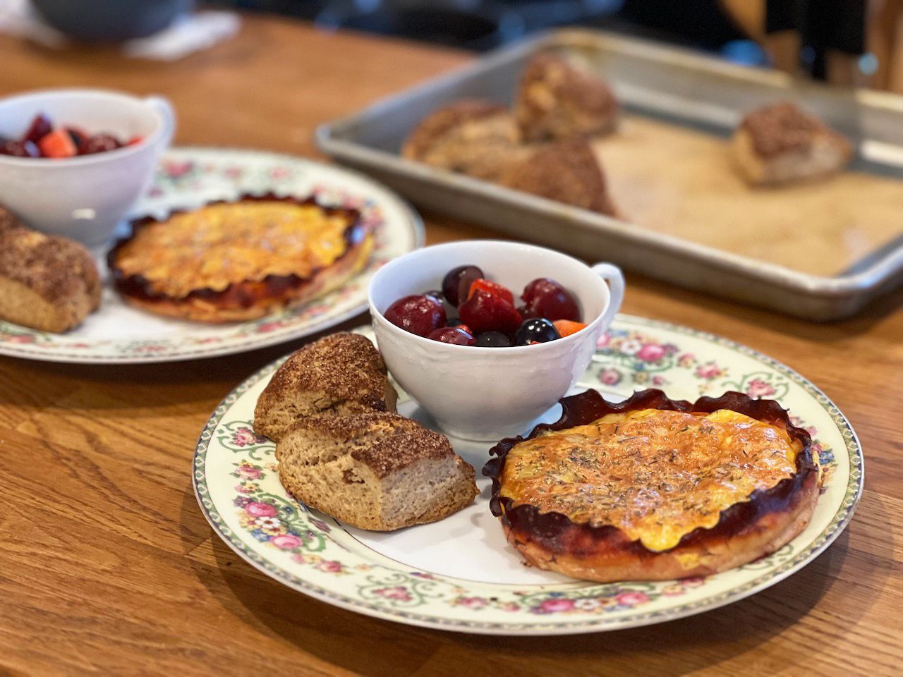 A plate of food with a cup of berries on it