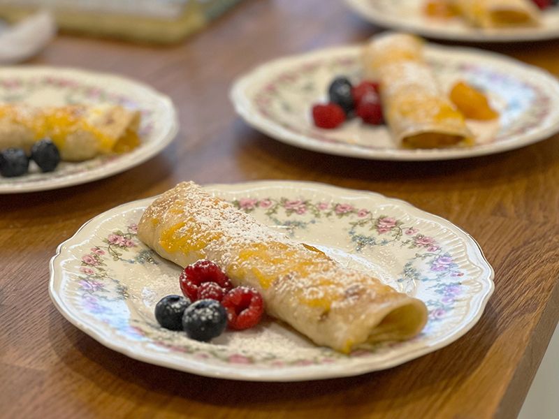 A close up of a plate of food with berries on a table.