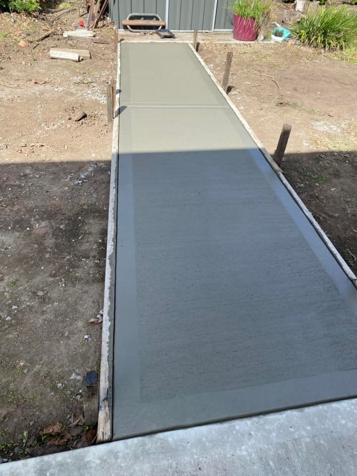 Long Concrete Path Leading To A Doorway Outdoors — BJ's Concreting in North Nowra, NSW