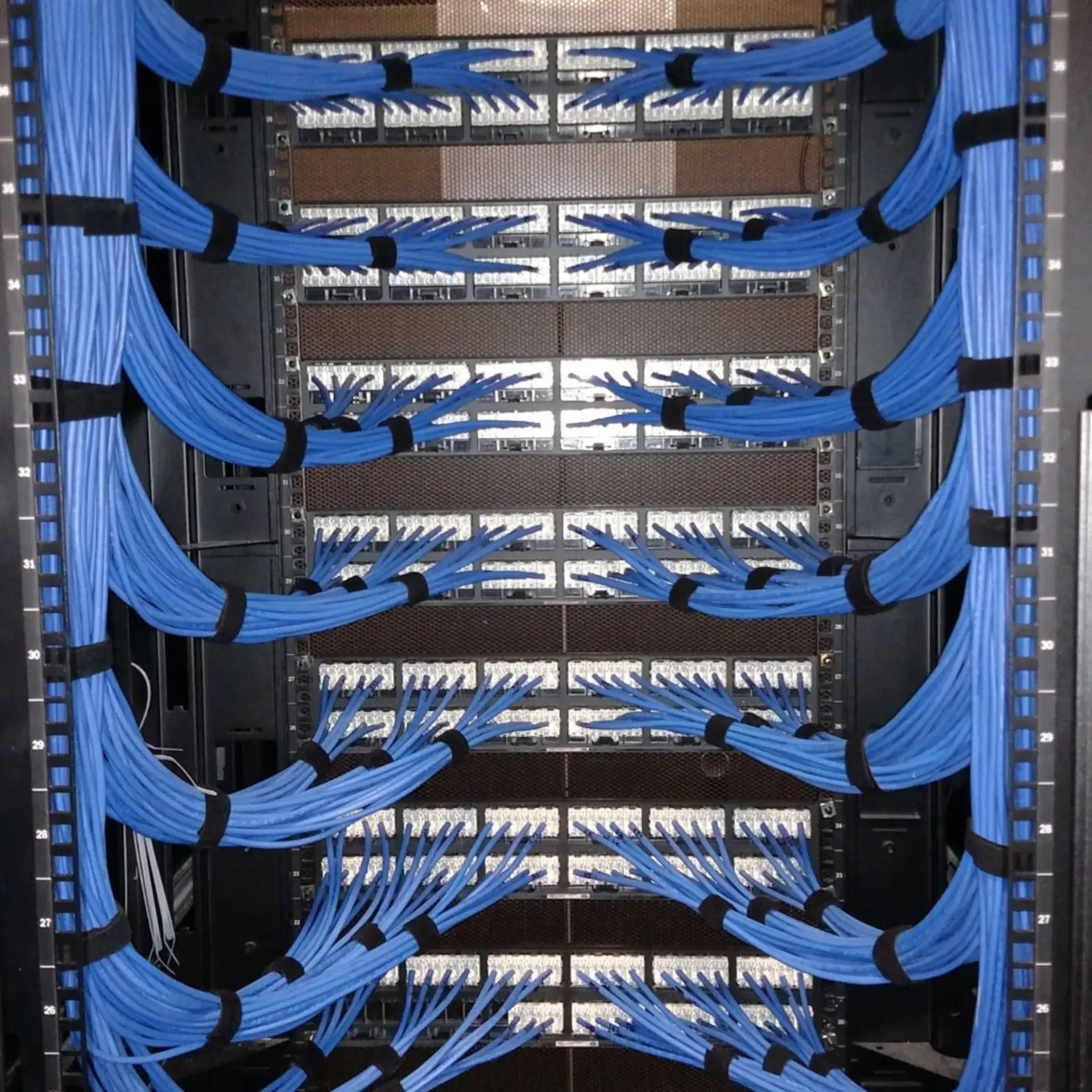 Robinson Electric Company - A bunch of blue wires are connected to a server rack
