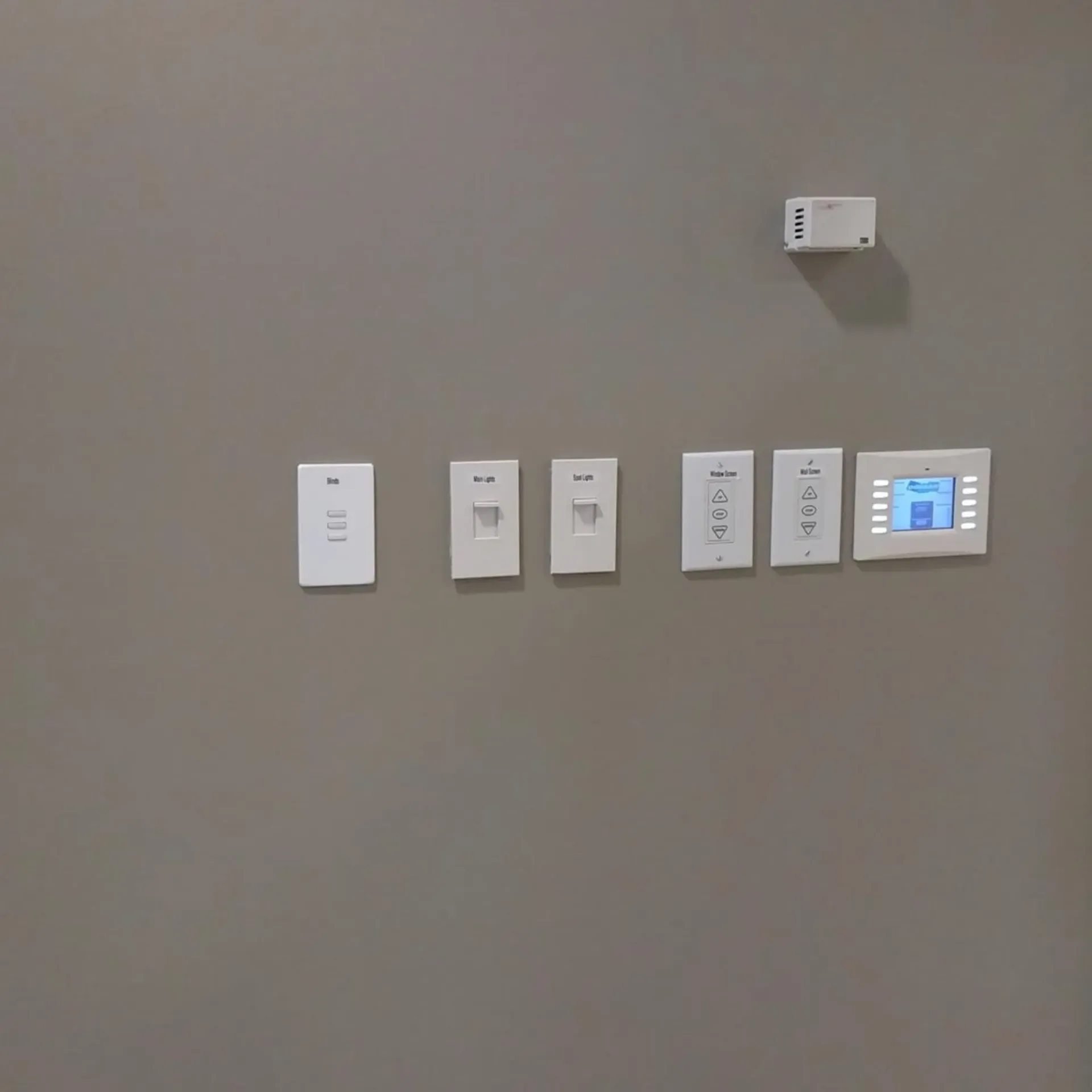 Robinson Electric Company - A wall with a bunch of light switches and a thermostat on it.