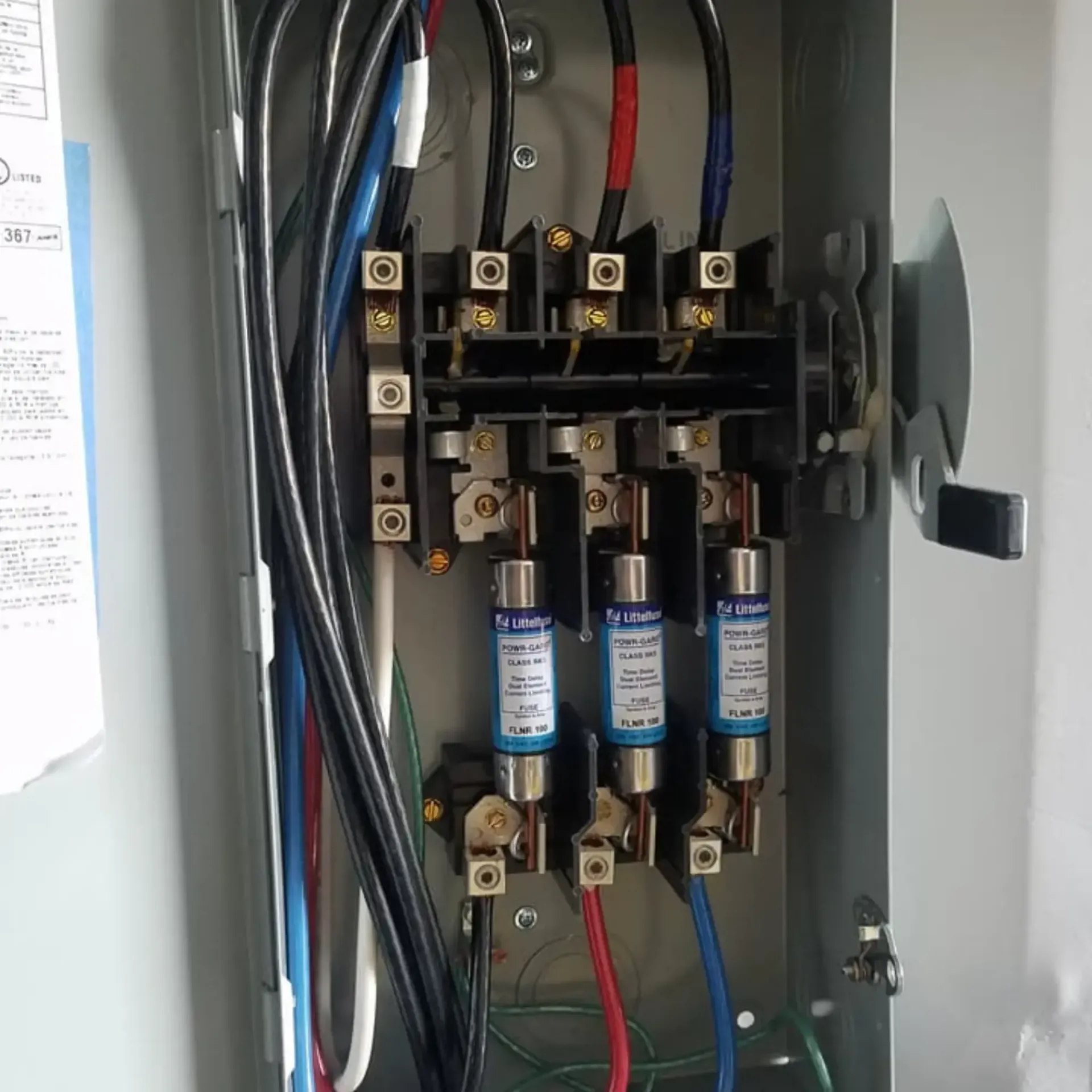 Robinson Electric Company -A close up of an electrical box with fuses and wires