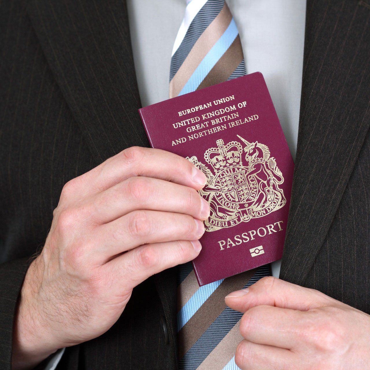 Businessman presenting a British passport at customs or check in area
