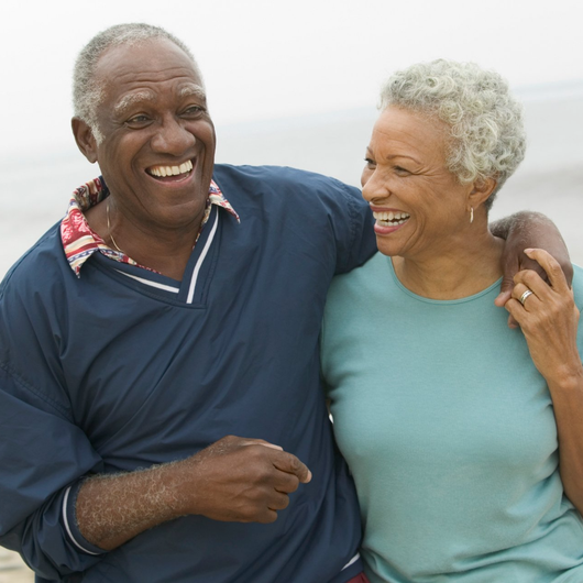 happy elderly african-american couple on beach