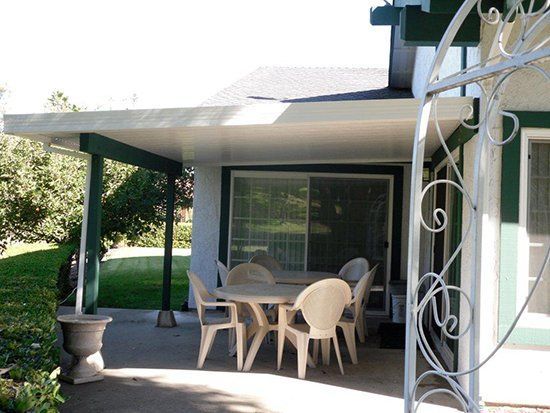 Concrete Patio with White Chairs - Chula Vista, CA - Velazquez Patio Construction Inc