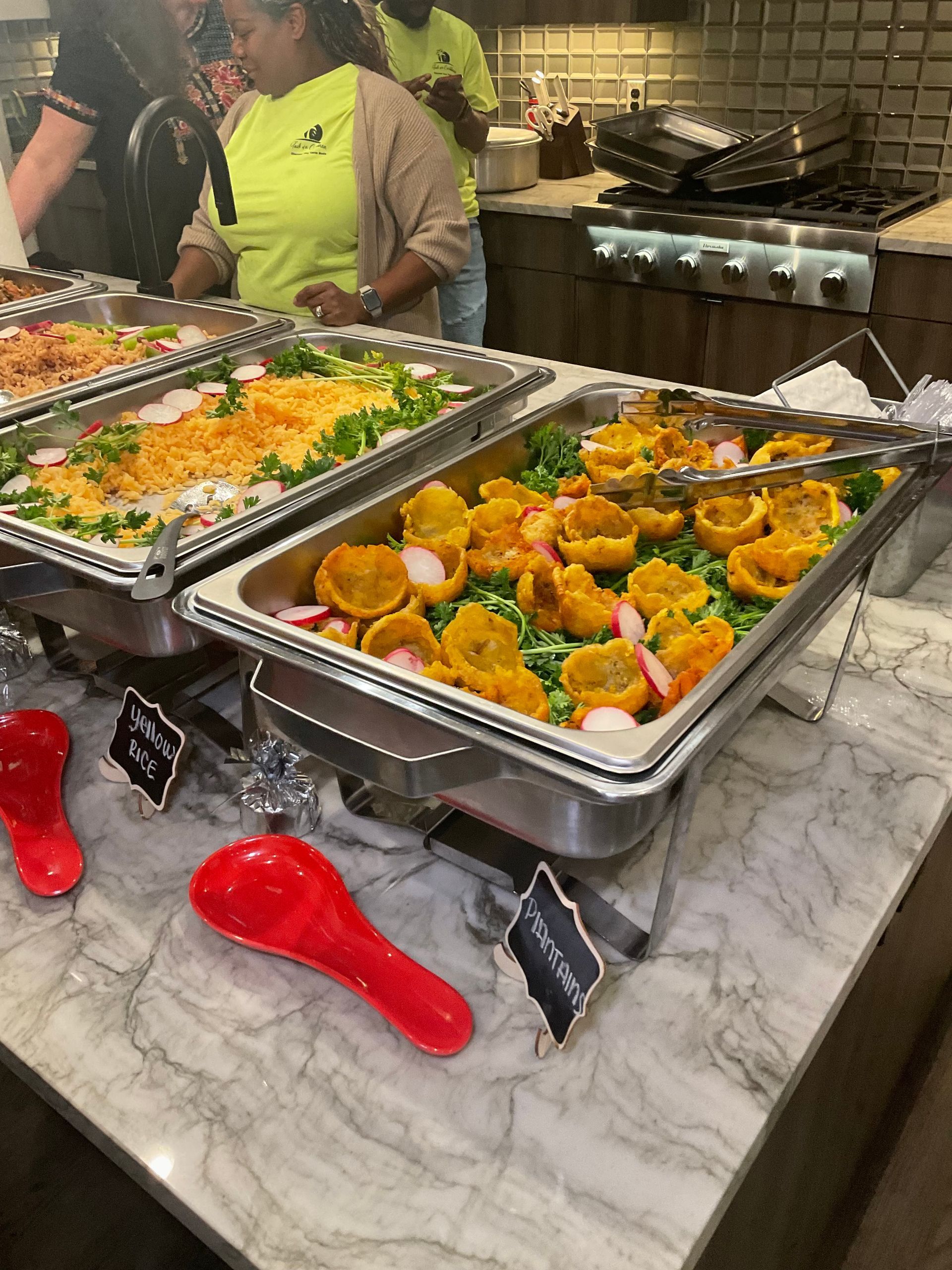 Rice dish in a rectangular stainless steel tray. The rice is a brownish-orange color and appears to have other ingredients mixed in. Prepared for a Wedding.