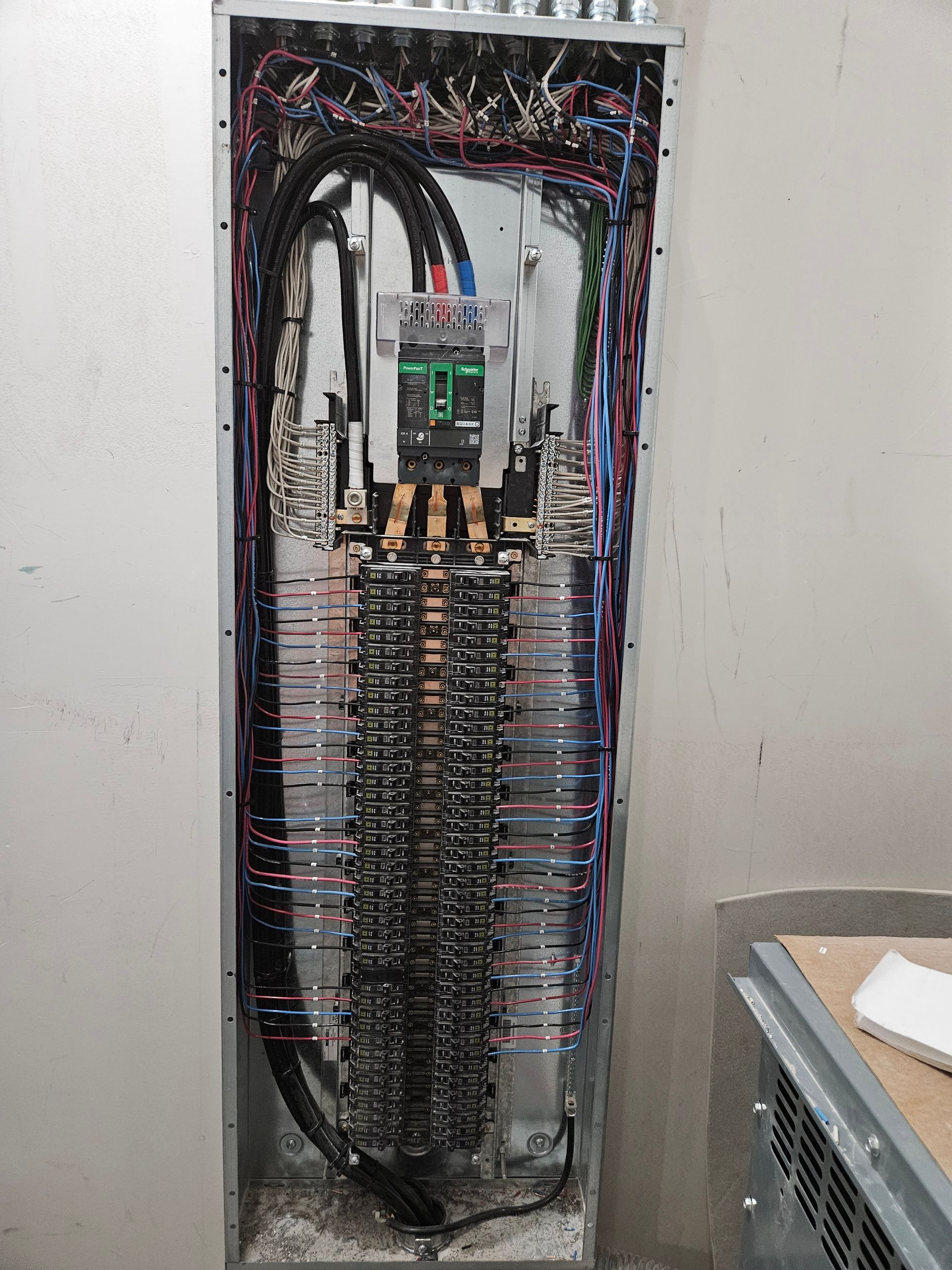 A large electrical box with a lot of wires coming out of it.