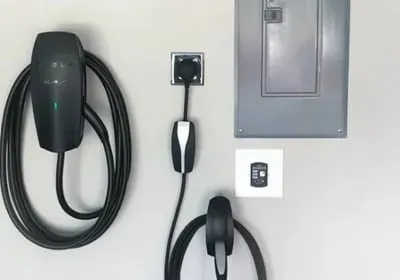A close up of a tesla charging station on a wall.