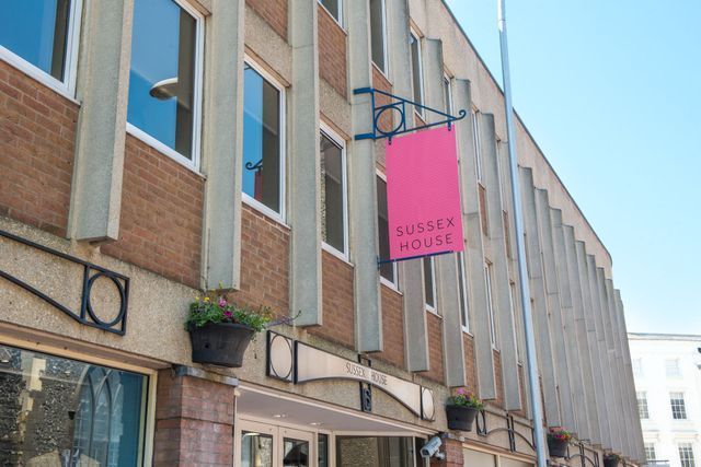 Red-brick building with a sign reading
