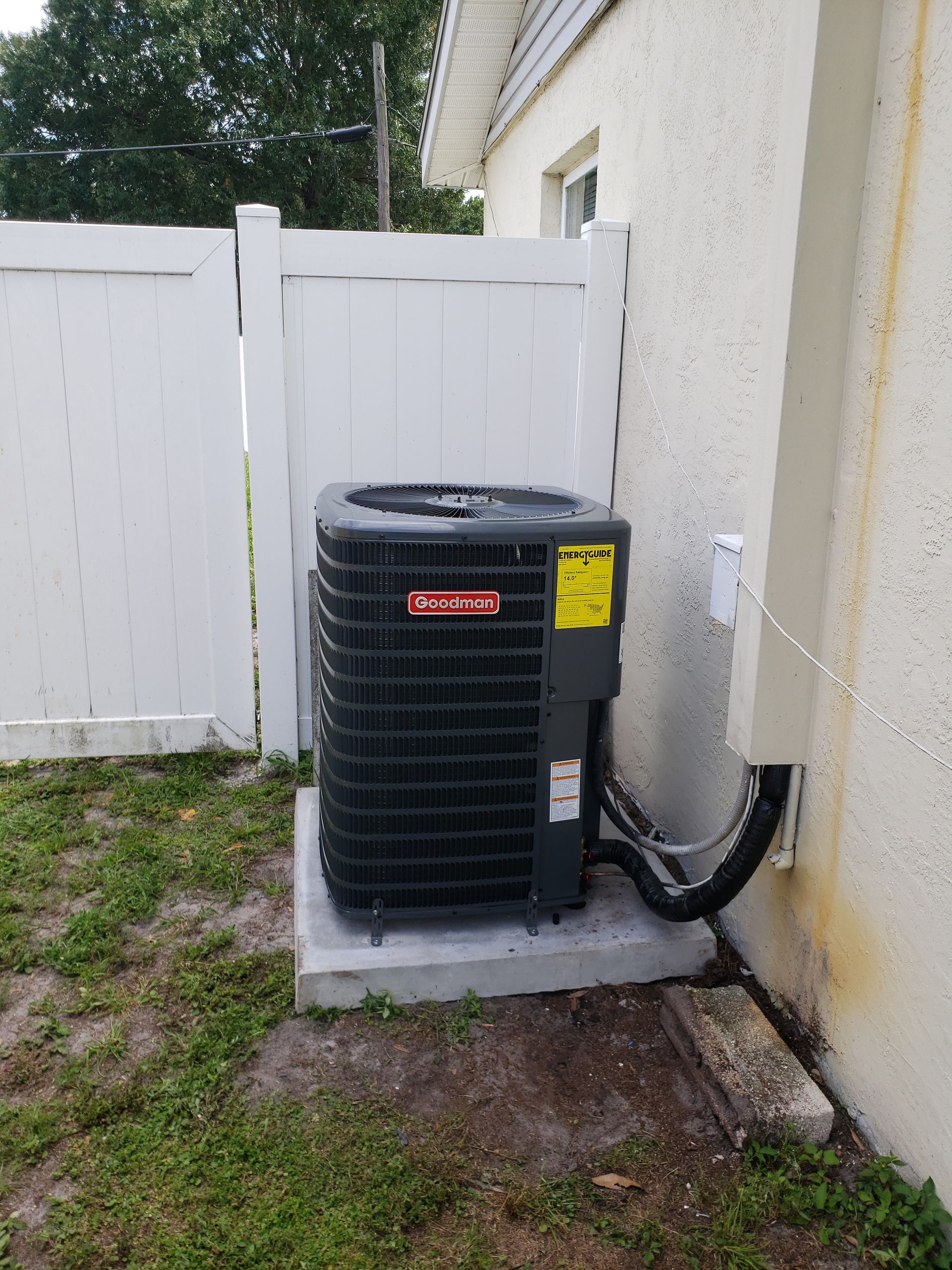 Outdoor heat pump unit surrounded by clear airflow space for proper operation.