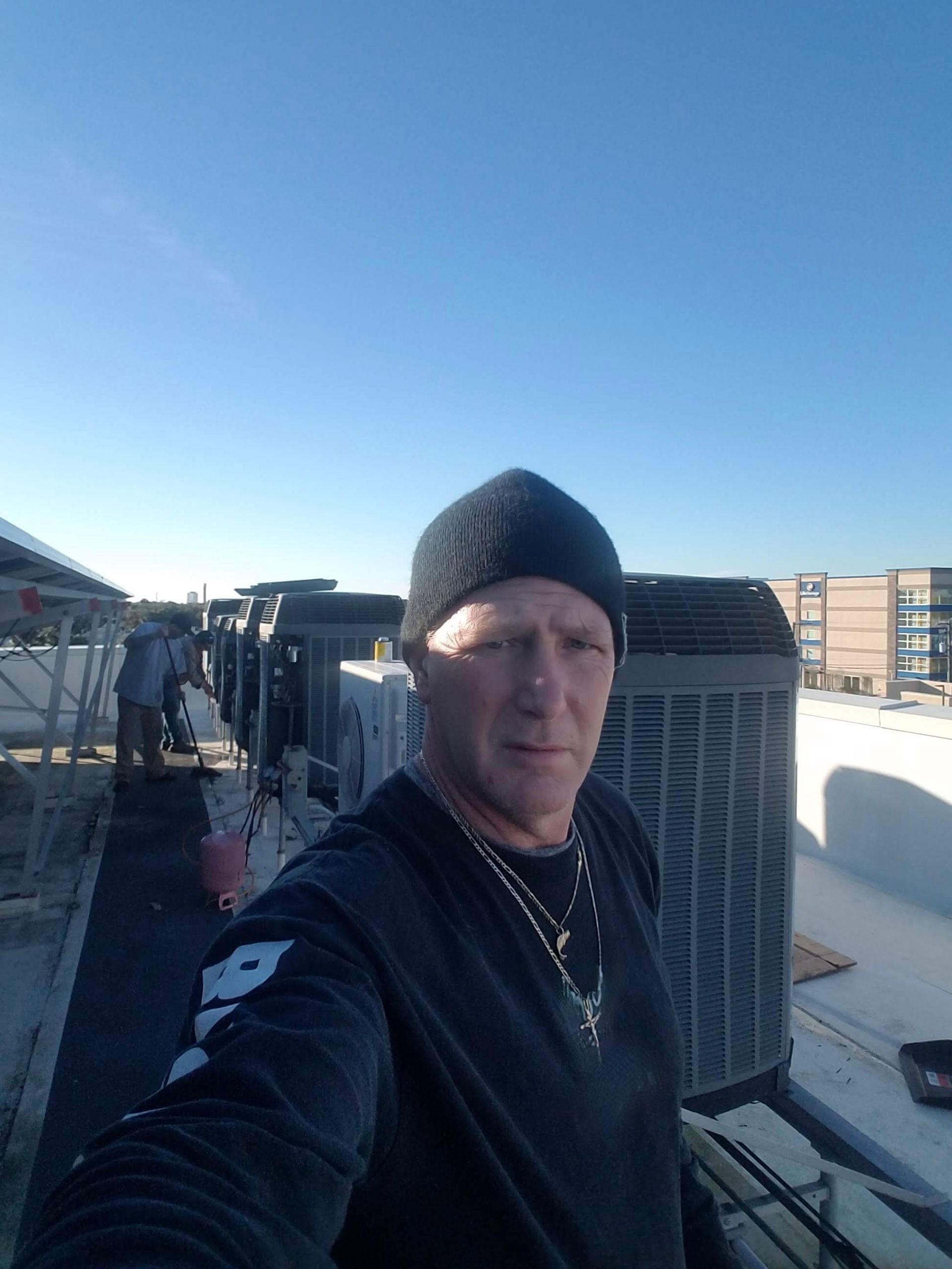 Family-owned and operated HVAC Company in Central Florida. Image: Owner working on AC's on a roof

