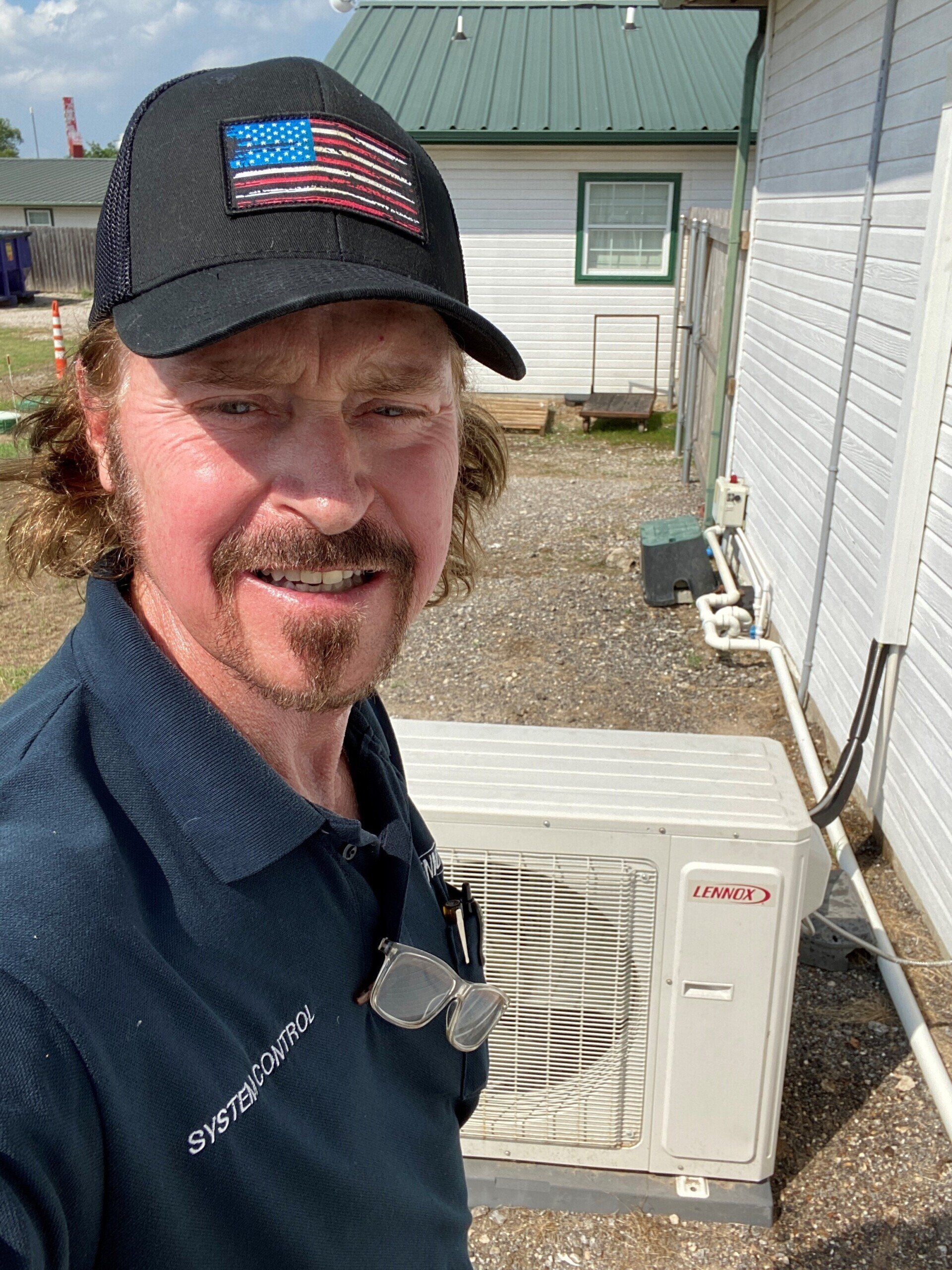 Aircon Unit Behind The Man — Terrell, TX — System Control Air Conditioning & Heating