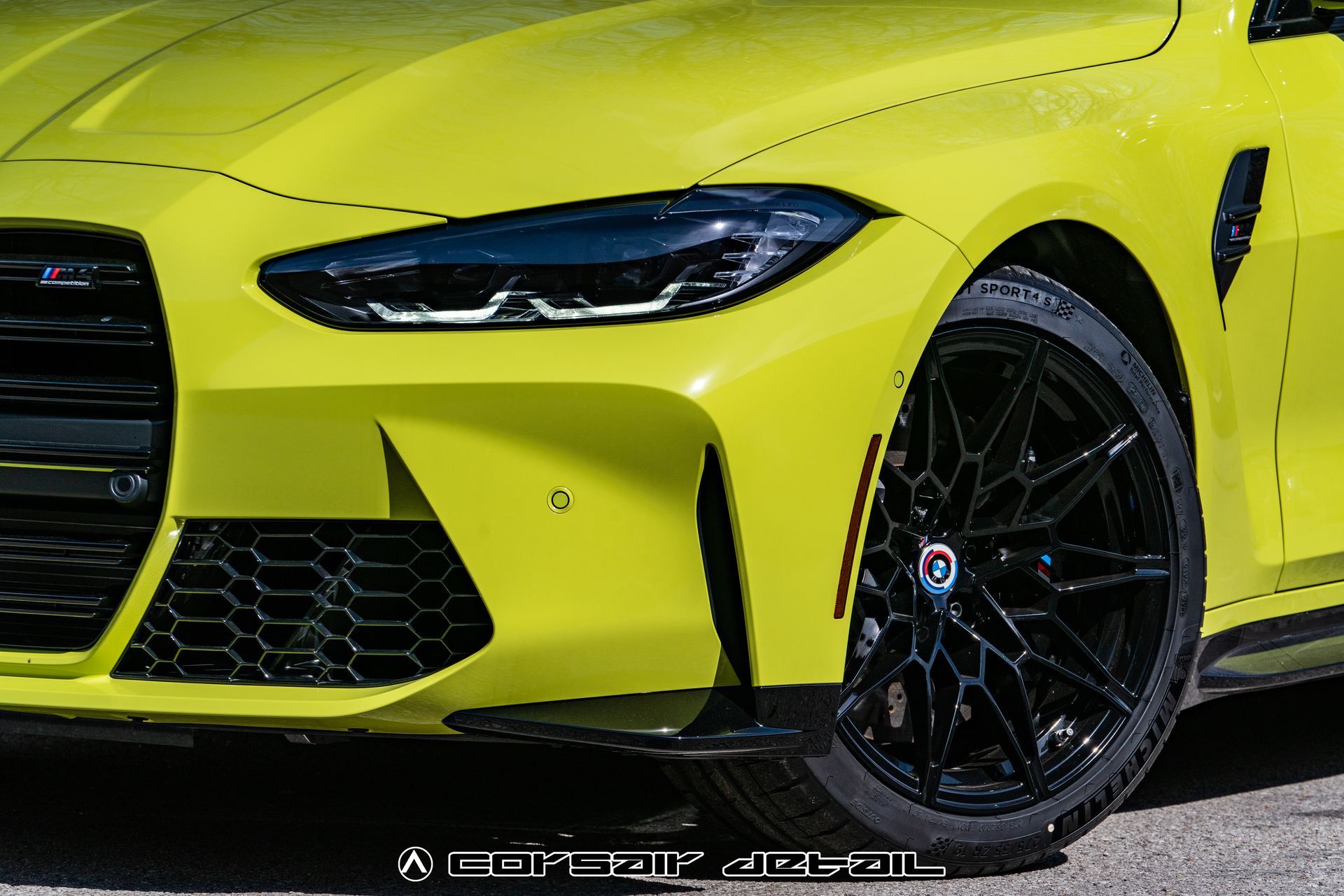 A close up of a yellow car with black wheels