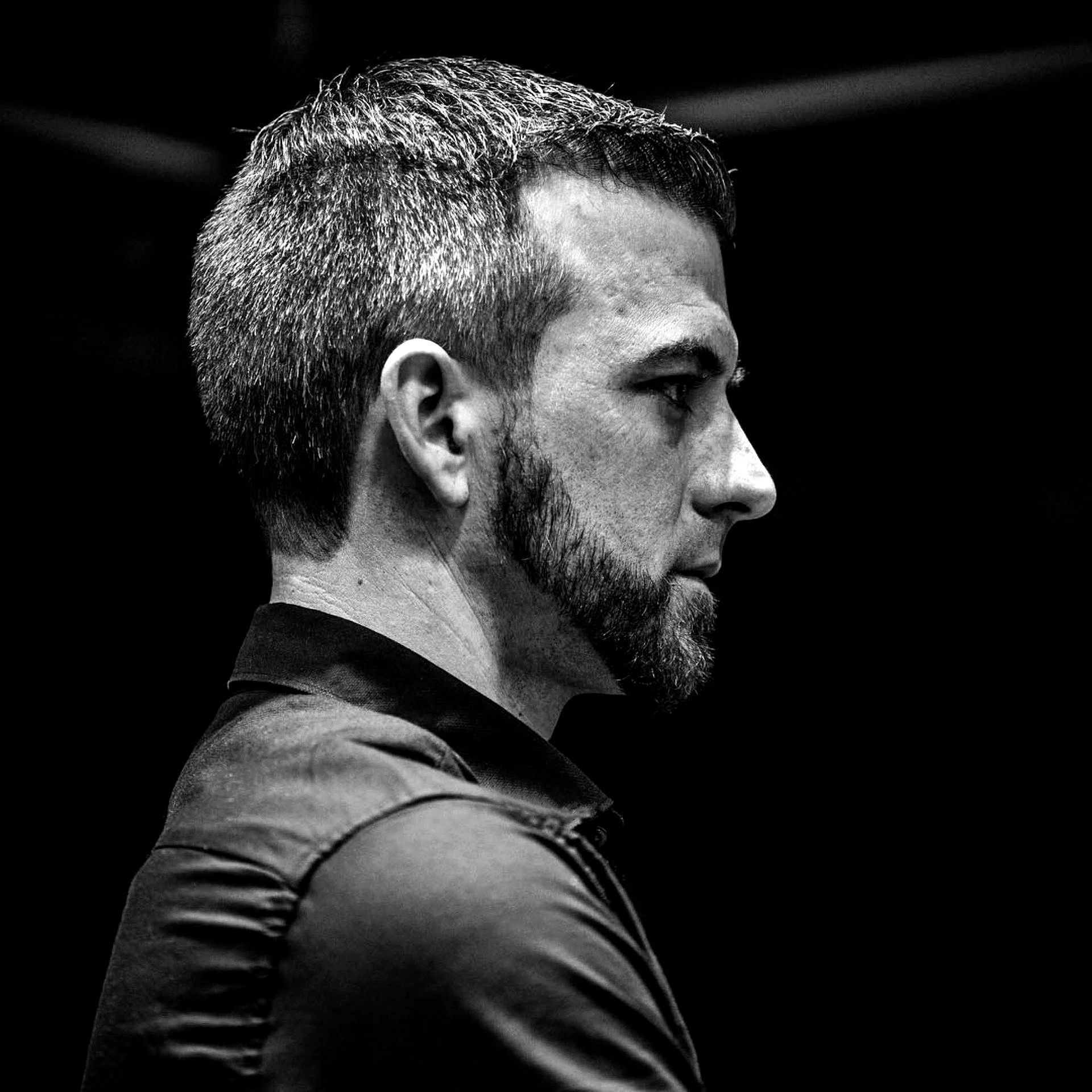 A black and white photo of a man with a beard.