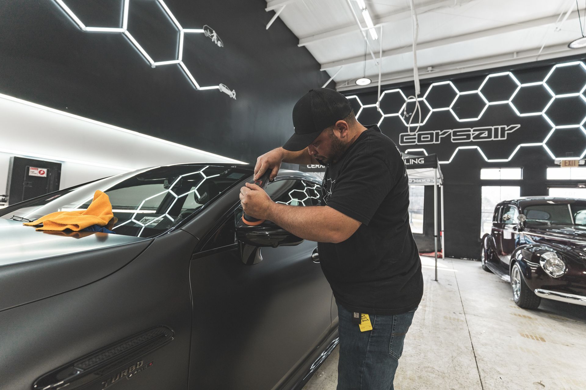 A man is working on a car in a garage.