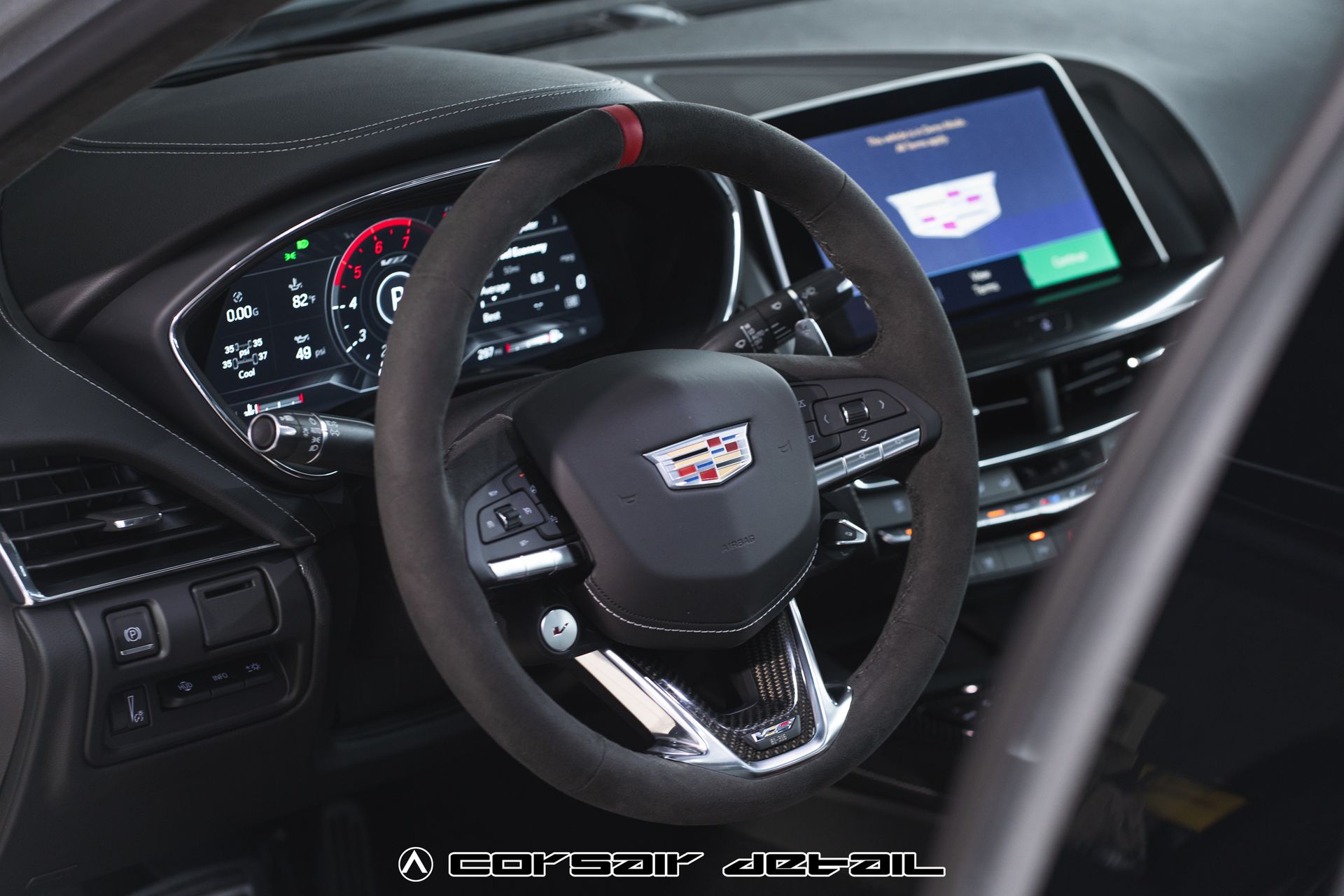 The interior of a cadillac with a steering wheel