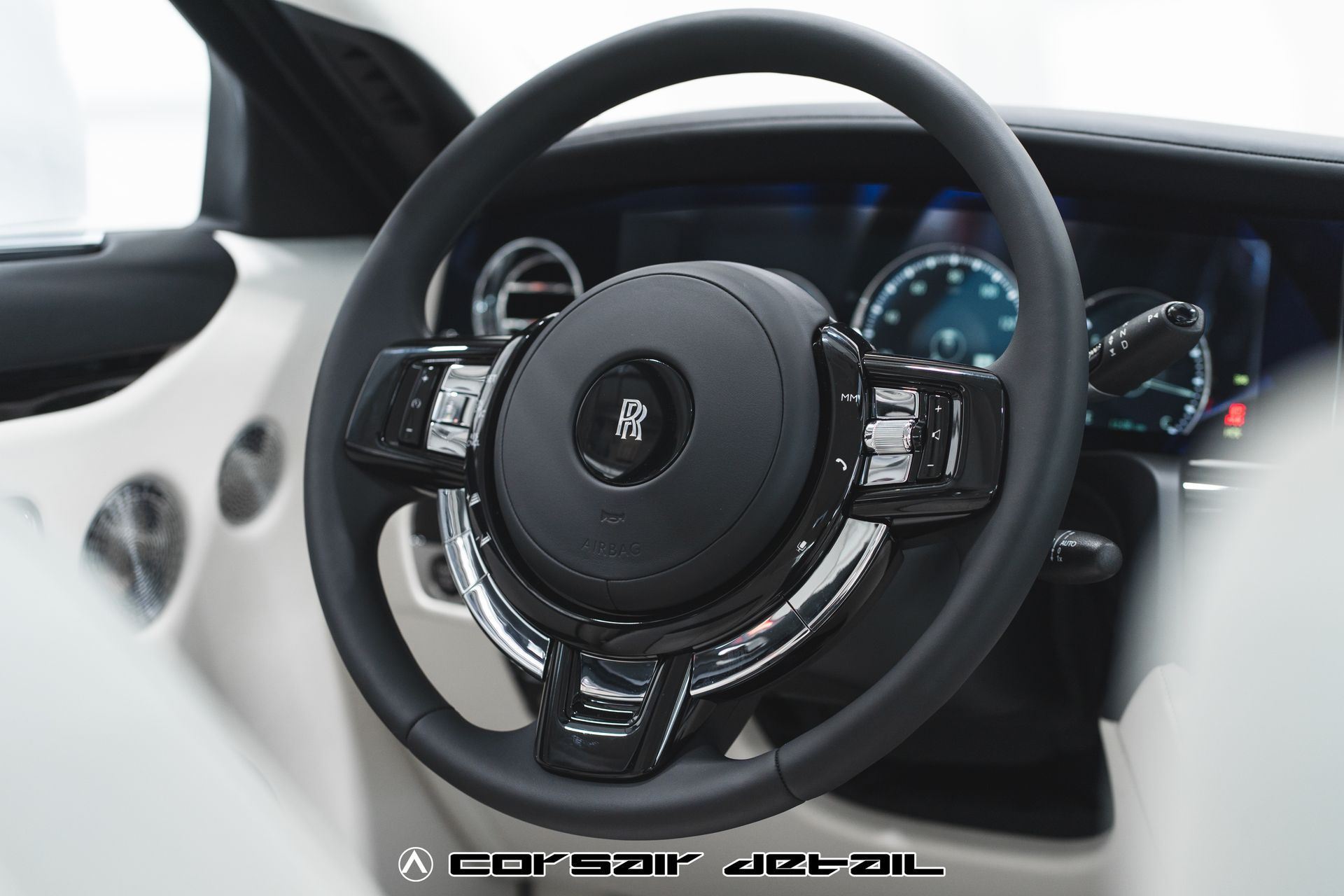 A close up of the steering wheel of a car