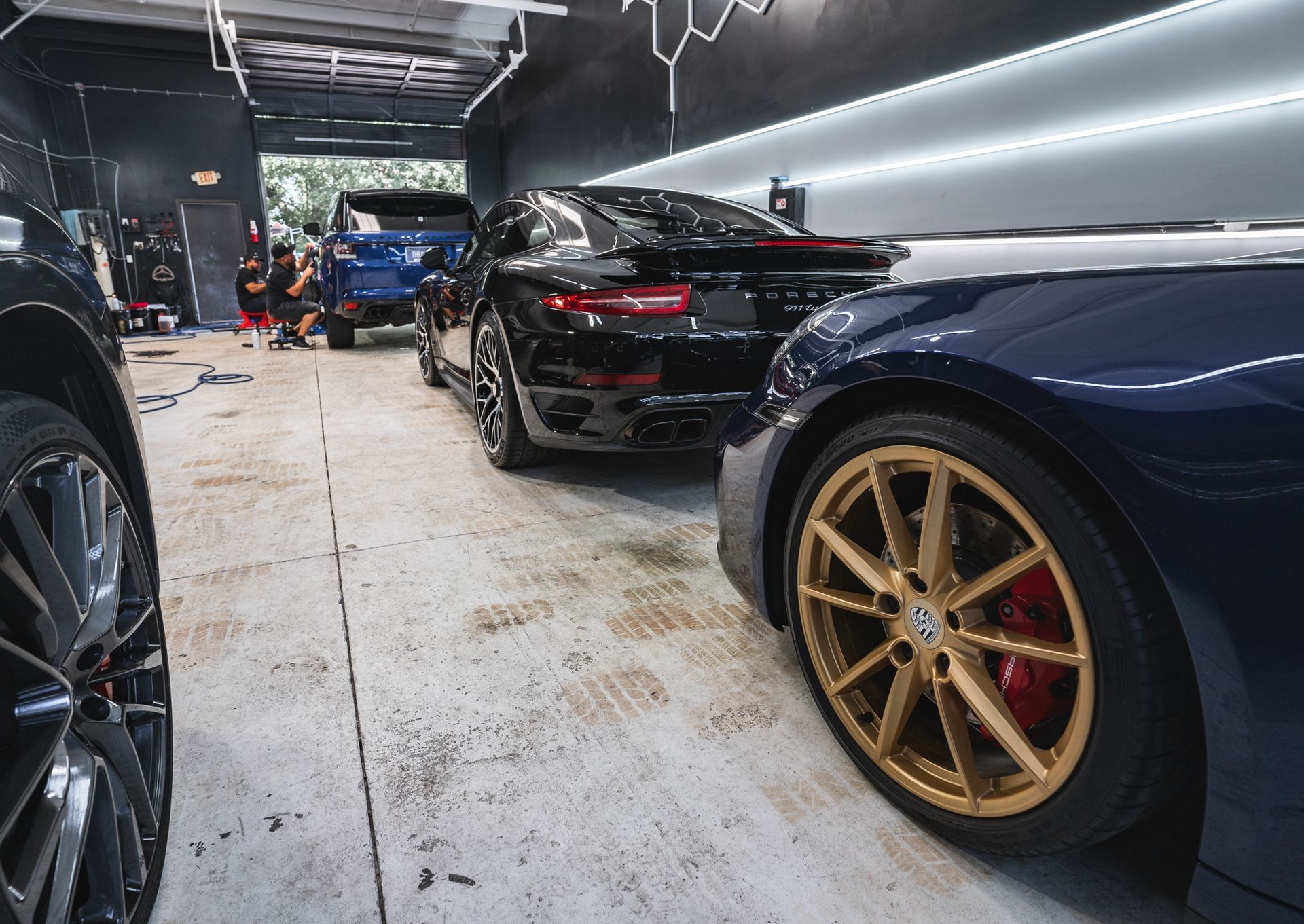 A group of cars are parked in a garage.