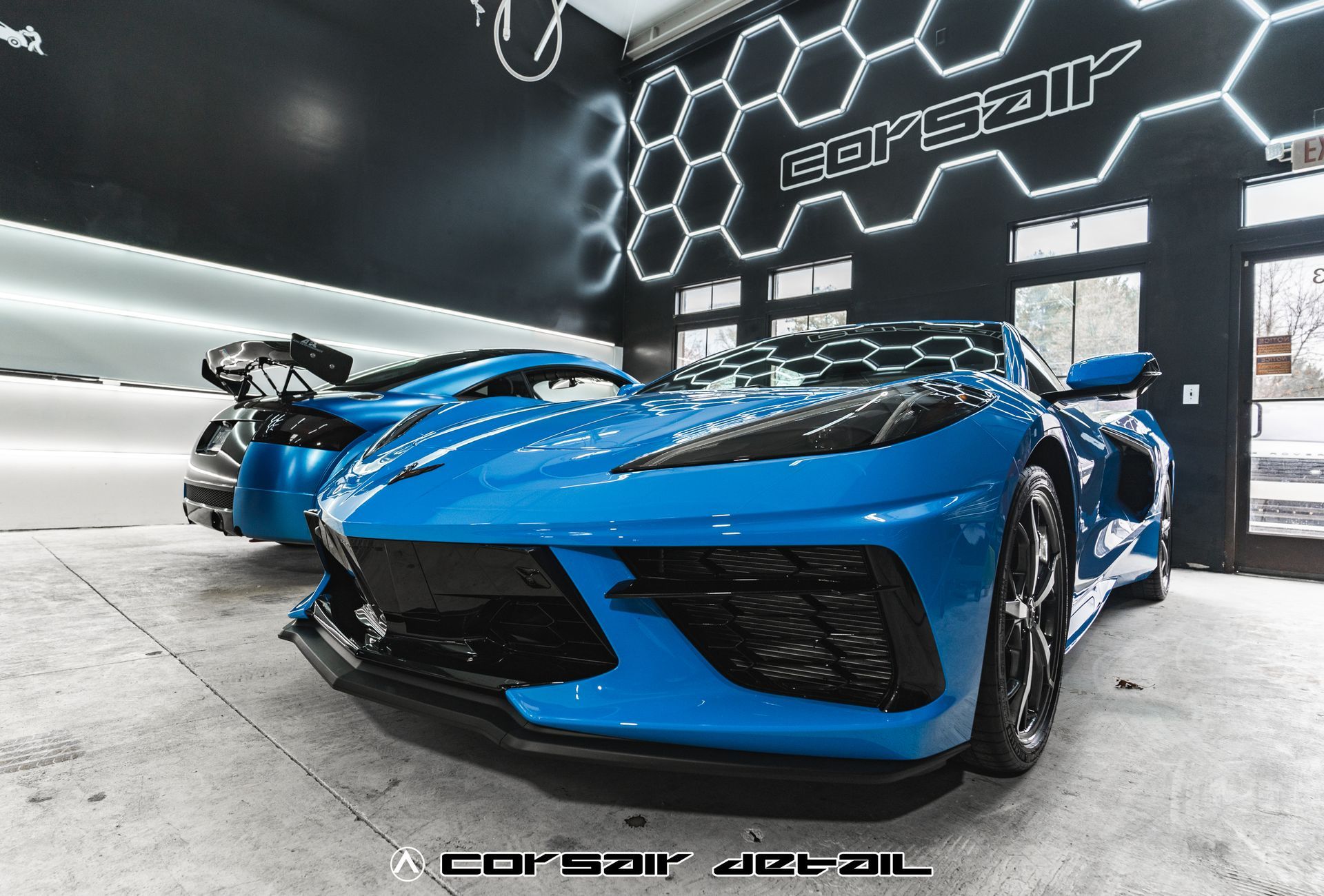 A blue sports car is parked in a garage.