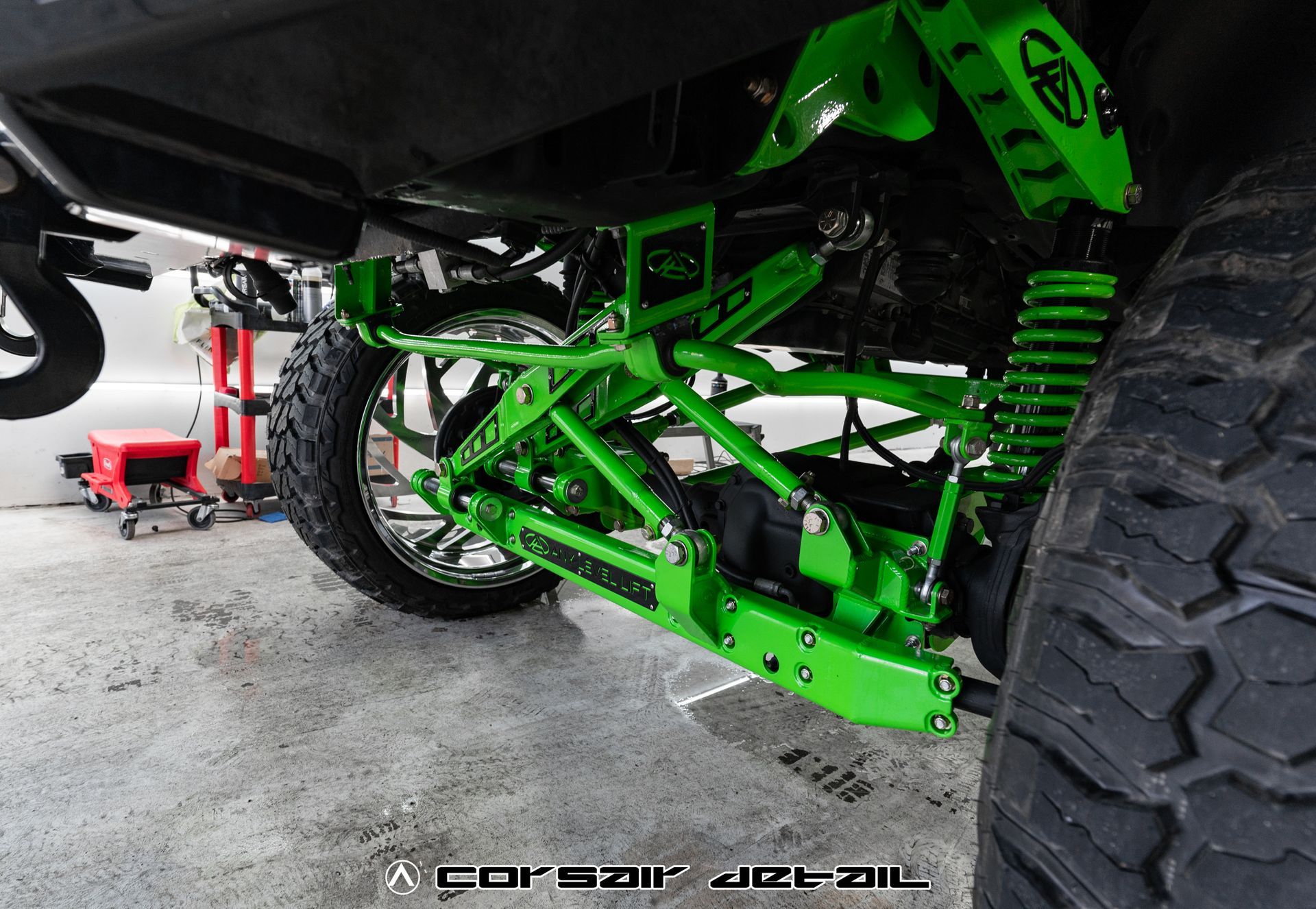 A close up of a green suspension system on a truck