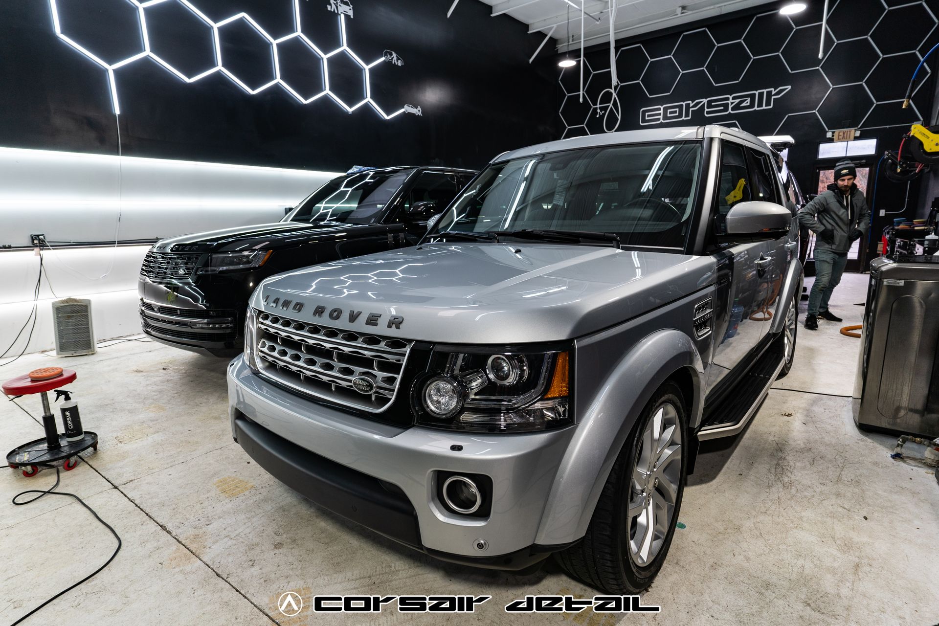 A silver range rover is parked in a car wash