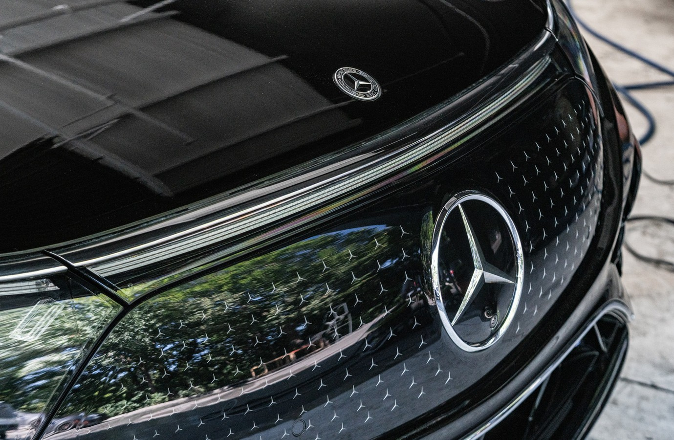A close up of the front of a black mercedes benz car