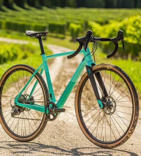 A Green Bicycle Is Parked On The Side Of A Dirt Road — Trinity Cycle Works In Cairns City, QLD